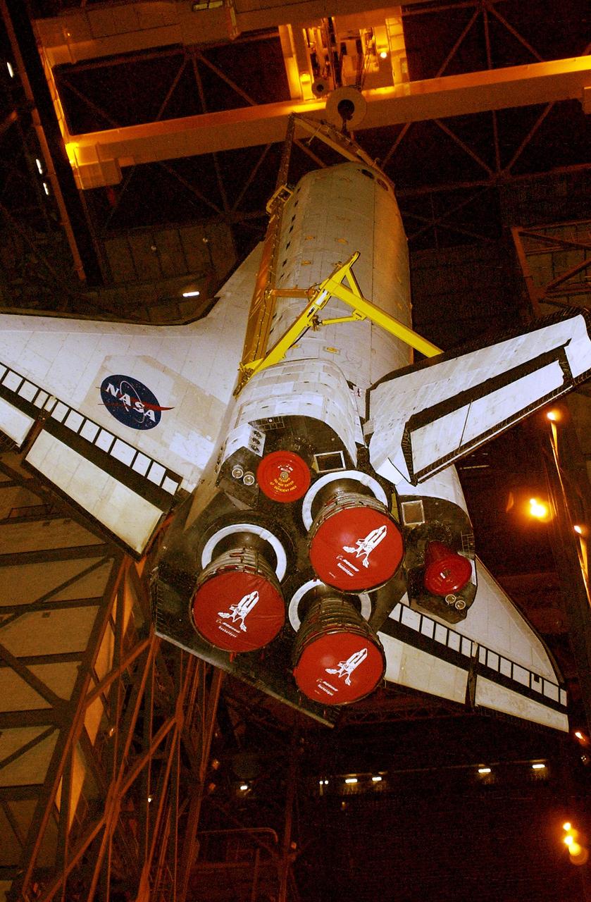 KENNEDY SPACE CENTER, Fla. - Atlantis is lowered toward the floor of the transfer aisle in the Vehicle Assembly Building.   After demating from its external tank, Atlantis was lifted out of the high bay to the transfer aisle.  Atlantis will now be moved to the Orbiter Processing Facility.
