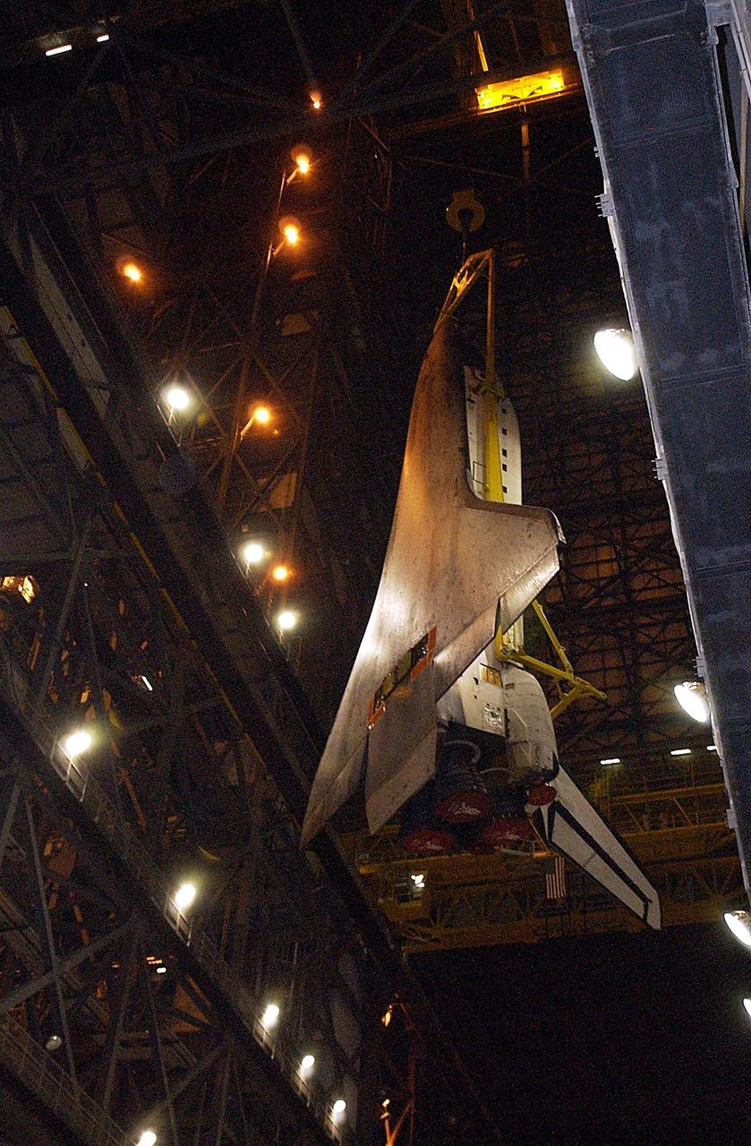KENNEDY SPACE CENTER, Fla. - Atlantis is lowered toward the floor of the transfer aisle in the Vehicle Assembly Building.   After demating from its external tank, Atlantis was lifted out of the high bay to the transfer aisle.  Atlantis will next be moved to the Orbiter Processing Facility.
