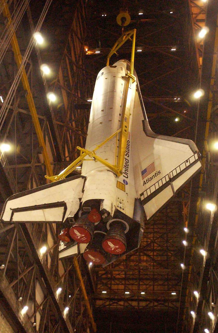 KENNEDY SPACE CENTER, Fla. - Atlantis is lowered toward the floor of the transfer aisle in the Vehicle Assembly Building.   After demating from its external tank, Atlantis was lifted out of the high bay to the transfer aisle.  Atlantis will next be moved to the Orbiter Processing Facility.