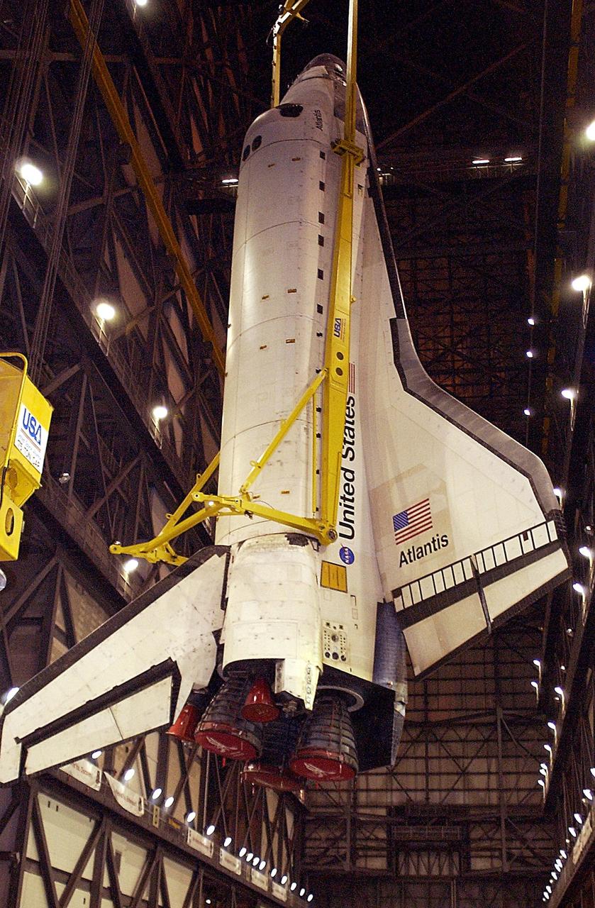 KENNEDY SPACE CENTER, Fla. - Atlantis is lowered toward the floor of the transfer aisle in the Vehicle Assembly Building.   After demating from its external tank, Atlantis was lifted out of the high bay to the transfer aisle.  Atlantis will next be moved to the Orbiter Processing Facility.