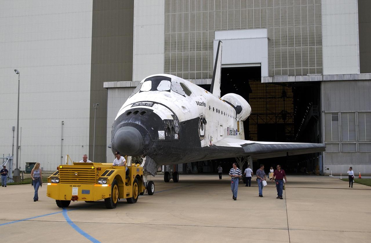 KENNEDY SPACE CENTER, Fla. - Atlantis is towed away from the Vehicle Assembly Building. The orbiter was demated from its external tank in the high bay, lifted over the transom, then lowered and shifted to the horizontal position in the transfer aisle. Atlantis is being moved to the Orbiter Processing Facility.
