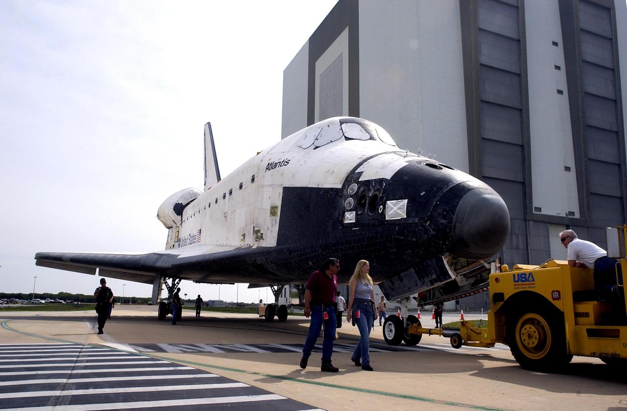KENNEDY SPACE CENTER, Fla. - Atlantis is towed away from the Vehicle Assembly Building. The orbiter was demated from its external tank in the high bay, lifted over the transom, then lowered and shifted to the horizontal position in the transfer aisle. Atlantis is being moved to the Orbiter Processing Facility.