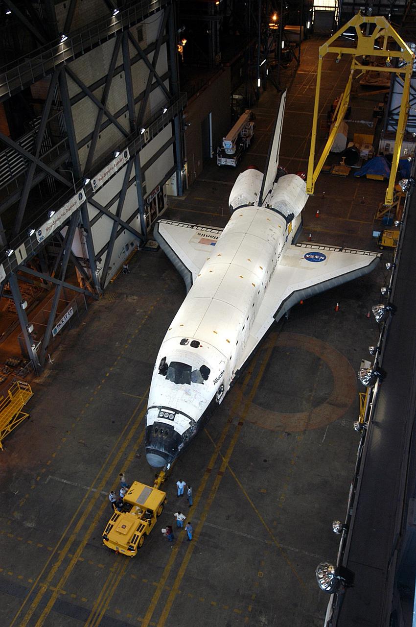 KENNEDY SPACE CENTER, Fla. -  Atlantis is towed away after being lowered into the transfer aisle of the Vehicle Assembly Building.  Not currently in  preparation for flight, the orbiter is being moved to the Orbiter Processing Facility.