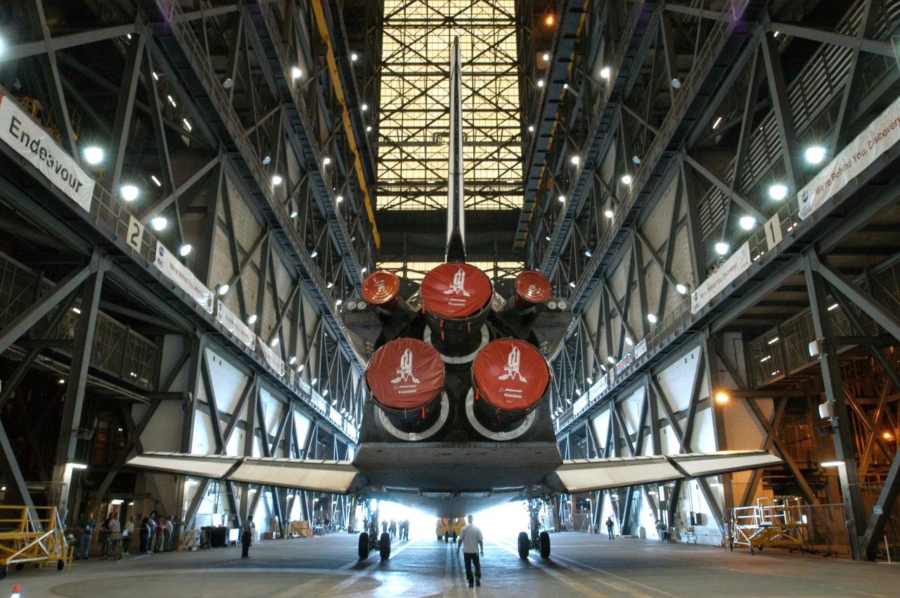 KENNEDY SPACE CENTER, Fla. -  Seen from behind, Atlantis is towed away after being lowered into the transfer aisle of the Vehicle Assembly Building.  Not currently in  preparation for flight, the orbiter is being moved to the Orbiter Processing Facility.