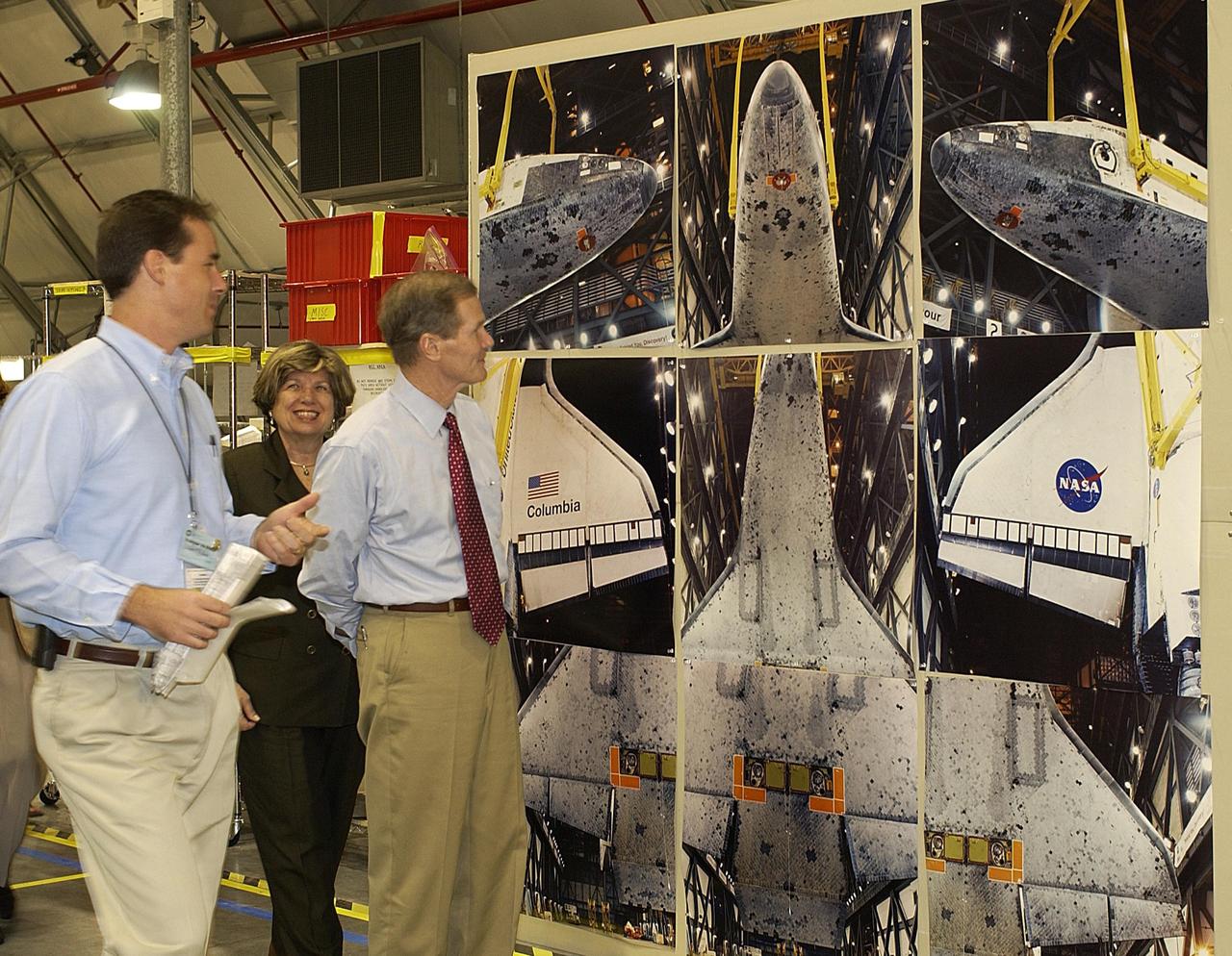 KENNEDY SPACE CENTER, FLA. --  In the RLV Hangar, Space Shuttle Test Director Steve Altemus (left) describes to U.S. Senator Bill Nelson (right) the images on an exhibit, part of the reconstruction efforts of Columbia.  Accompanying them is JoAnn Morgan, director of KSC's External Relations and Business Development.