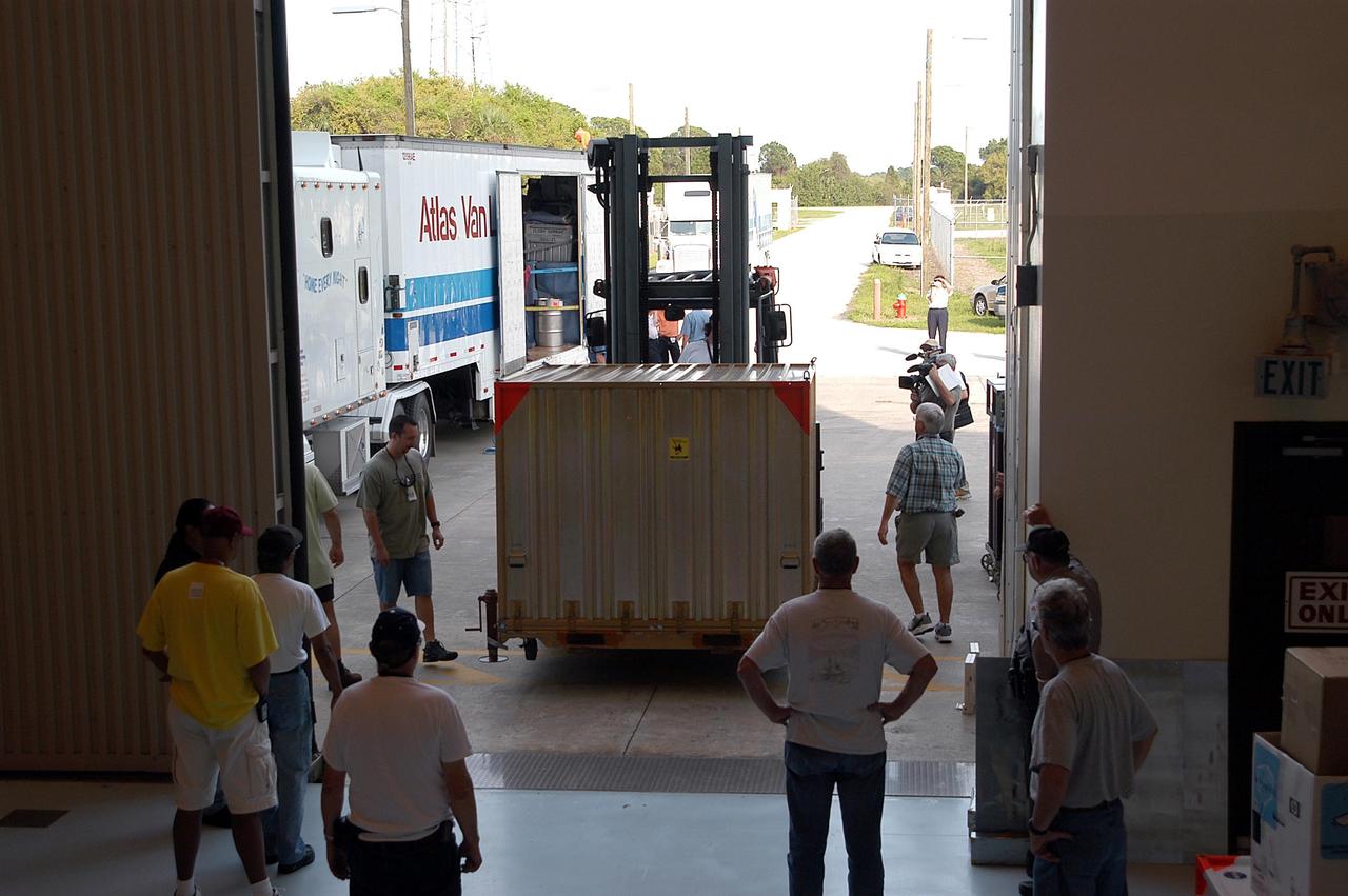 KENNEDY SPACE CENTER, Fla. - Outside the Payload Hazardous Servicing Facility, the second Mars Exploration Rover (MER-1), in its shipping container, is moved inside. MER-2 and other hardware have already arrived at KSC for processing. MER-1 will begin prelaunch testing, including deployment of the lander petals, the rover's solar arrays, camera mast and camera. While at KSC, each of the rovers, their aeroshells and landers will undergo a full mission simulation. After spin balance testing, each spacecraft will be mated to a solid propellant upper stage booster that will propel the spacecraft out of Earth orbit. Approximately 10 days before launch they will be transported to the launch pad for mating with their respective Boeing Delta II rockets. The rovers will serve as robotic geologists to seek answers about the evolution of Mars, particularly for a history of water. The rovers are identical to each other, and will land at different regions of Mars. Launch of the MER-1 is scheduled for May 30. MER-2 will follow June 25.