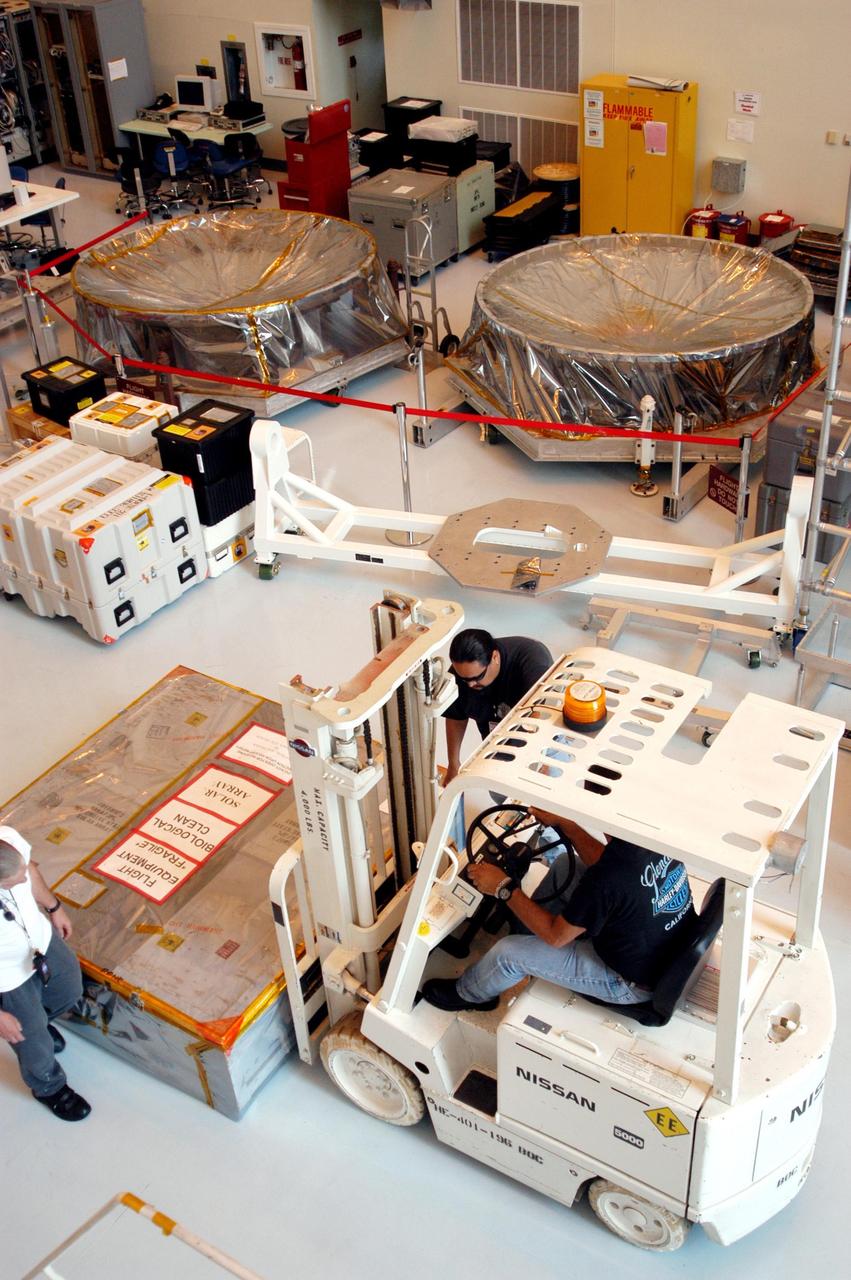 KENNEDY SPACE CENTER, Fla. - More Mars hardware is moved into the Payload Hazardous Servicing Facility, which already holds one of the Mars Exploration Rovers (MER) and the aeroshells and landers for both rovers. While at KSC, MER-1 and MER-2, their aeroshells and landers will undergo a full mission simulation. After spin balance testing, each spacecraft will be mated to a solid propellant upper stage booster that will propel the spacecraft out of Earth orbit. Approximately 10 days before launch they will be transported to the launch pad for mating with their respective Boeing Delta II rockets. The rovers will serve as robotic geologists to seek answers about the evolution of Mars, particularly for a history of water. The rovers are identical to each other, and will land at different regions of Mars. Launch of the MER-1 is scheduled for May 30. MER-2 will follow June 25.