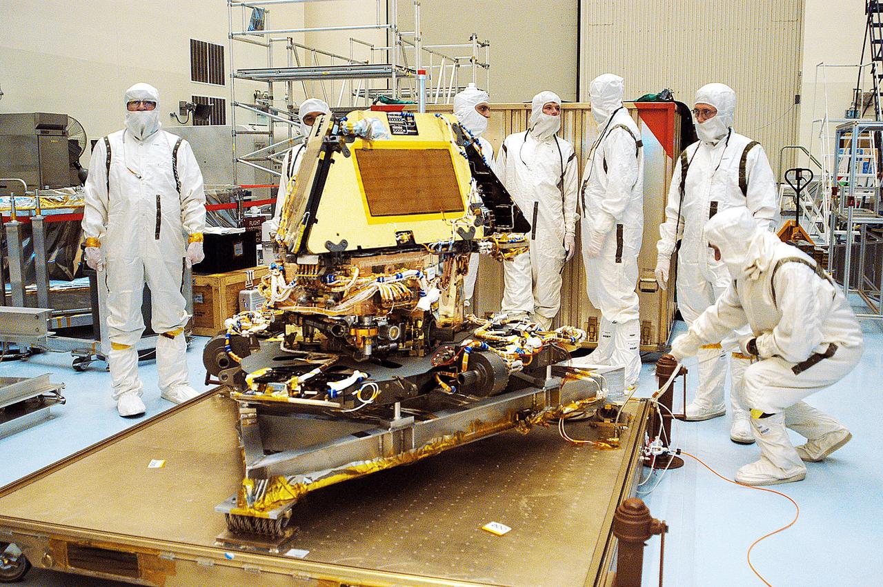 KENNEDY SPACE CENTER, Fla. -  The second Mars Exploration Rover, MER-1, sits revealed on a platform in the Payload Hazardous Servicing Facility after being unwrapped .  MER-2 and other hardware have already arrived at KSC for processing.  MER-1 will undergo prelaunch testing, including deployment of the lander petals, the rover's solar arrays, camera mast and camera.  While at KSC, each of the rovers, their aeroshells and landers will undergo a full mission simulation. After spin balance testing,  each spacecraft will be mated to a solid propellant upper stage booster that will propel the spacecraft out of Earth orbit. Approximately 10 days before launch they will be transported to the launch pad for mating with their respective Boeing Delta II rockets. The rovers will serve as robotic geologists to seek answers about the evolution of Mars, particularly  for a history of water. The rovers are identical to each other, and will land at different regions of Mars.  Launch of the MER-1 is scheduled for May 30.  MER-2 will follow June 25.