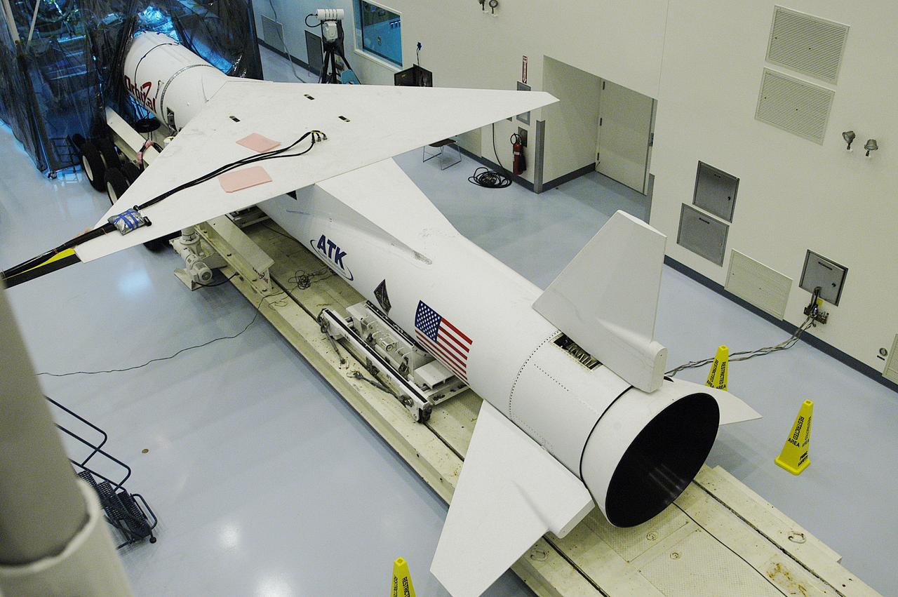 In the Multi-Payload Processing Facility, the Pegasus XL launch vehicle is in position for mating of the Galaxy Evolution Explorer (GALEX) satellite. The GALEX, set to launch April 2 from Cape Canaveral Air Force Station, will carry into space an orbiting telescope that will observe a million galaxies across 10 billion years of cosmic history to help astronomers determine when the stars and elements we see today had their origins. The spacecraft will sweep the skies for 28 months using state-of-the-art ultraviolet detectors to single out galaxies dominated by young, hot, short-lived stars that give off a great deal of energy at that wavelength. These galaxies are actively creating stars, and therefore provide a window into the history and causes of star formation in galaxies.