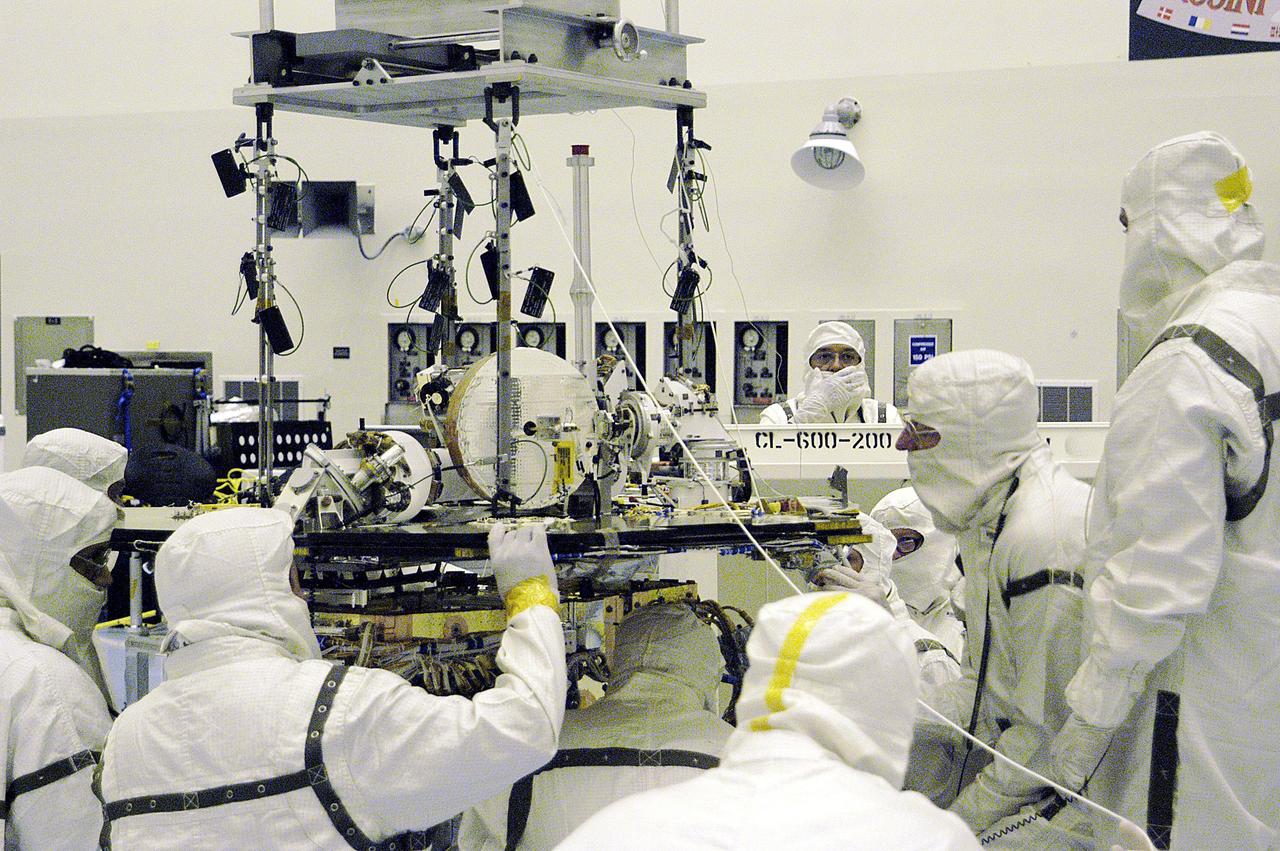KENNEDY SPACE CENTER, FLA. - In the Payload Hazardous Servicing Facility, workers align the Rover Equipment Deck (RED) on one of the Mars Exploration Rovers (MER) with the Warm Electronics Box (WEB). Processing of the rovers, plus cruise stage, lander and heat shield elements, is ongoing. Set to launch in 2003, the MER Mission will consist of two identical rovers designed to cover roughly 110 yards each Martian day. Each rover will carry five scientific instruments that will allow it to search for evidence of liquid water that may have been present in the planet's past. The rovers will be identical to each other, but will land at different regions of Mars. The first rover has a launch window opening May 30, and the second rover a window opening June 25, 2003.