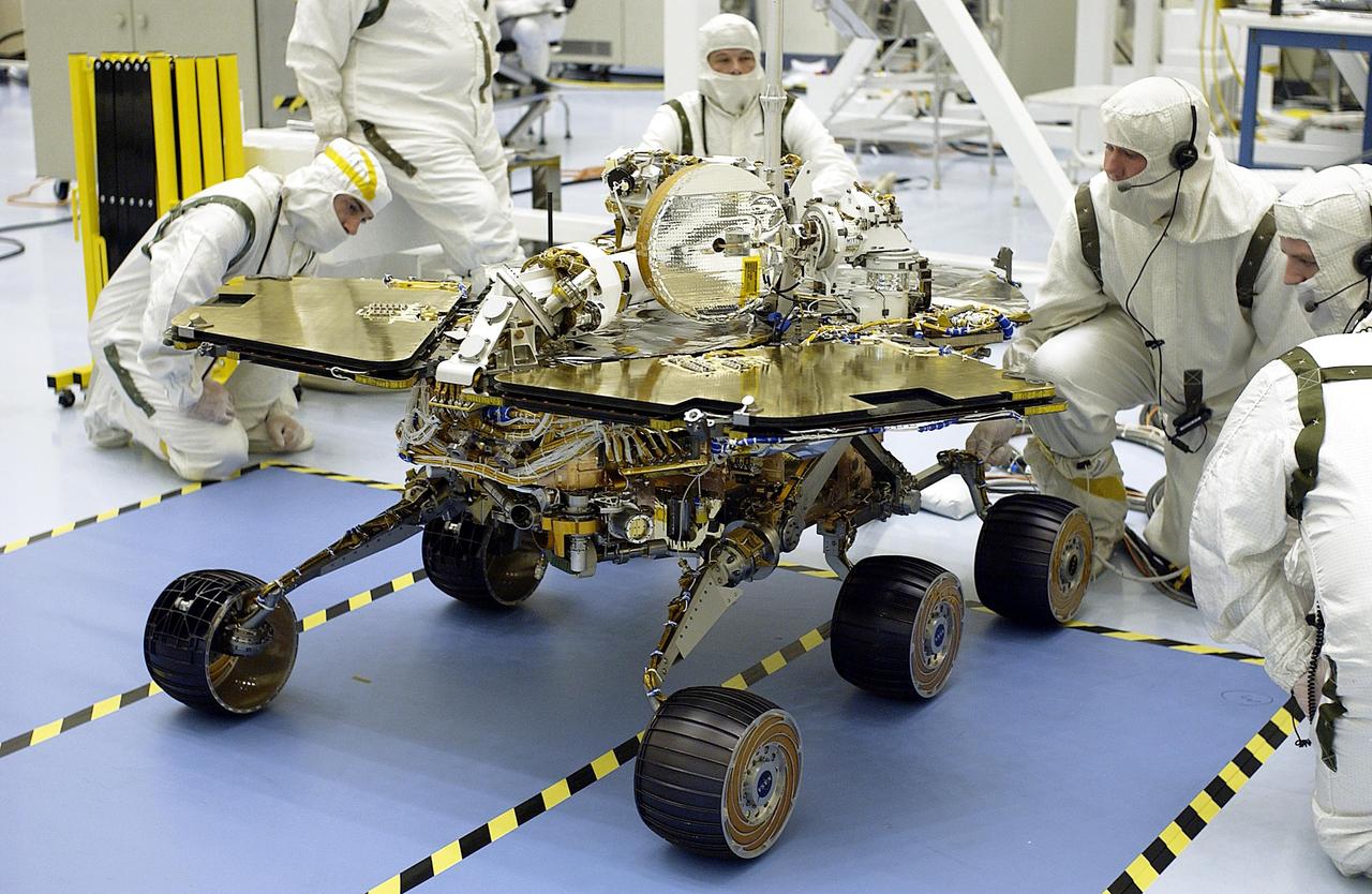 KENNEDY SPACE CENTER, Fla. - Workers in the Payload Hazardous Servicing Facility look at the Mars Exploration Rover-2 (MER-2) with its solar arrays fully open. On top can be seen the low-gain and high-gain antennas. Set to launch in Spring 2003, the MER Mission will consist of two identical rovers designed to cover roughly 110 yards each Martian day. Each rover will carry five scientific instruments that will allow it to search for evidence of liquid water that may have been present in the planet's past. The rovers will be identical to each other, but will land at different regions of Mars. The first rover has a launch window opening May 30, and the second rover a window opening June 25, 2003.