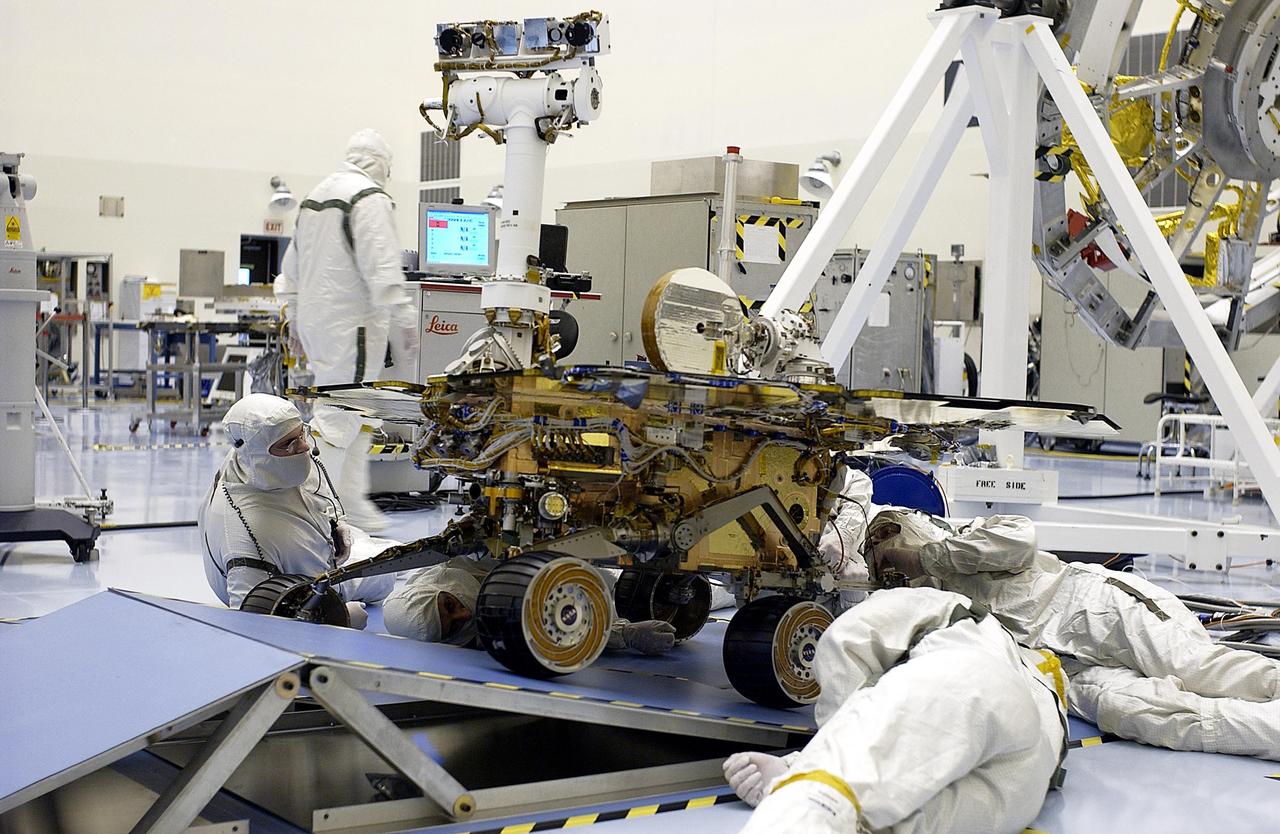 KENNEDY SPACE CENTER, Fla. - In the Payload Hazardous Servicing Facility, workers watch as the Mars Exploration Rover-2 (MER-2) rolls over ramps to test its mobility and maneuverability. Set to launch in Spring 2003, the MER Mission will consist of two identical rovers designed to cover roughly 110 yards each Martian day over various terrain. Each rover will carry five scientific instruments that will allow it to search for evidence of liquid water that may have been present in the planet's past. The rovers will be identical to each other, but will land at different regions of Mars. The first rover has a launch window opening May 30, and the second rover a window opening June 25.