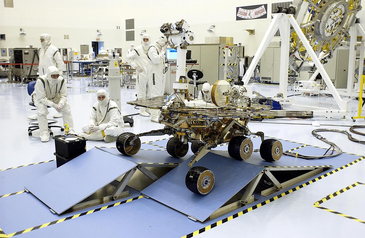 KENNEDY SPACE CENTER, Fla. - In the Payload Hazardous Servicing Facility, workers watch as the Mars Exploration Rover-2 (MER-2) rolls over ramps to test its mobility and maneuverability. Set to launch in Spring 2003, the MER Mission will consist of two identical rovers designed to cover roughly 110 yards each Martian day over various terrain. Each rover will carry five scientific instruments that will allow it to search for evidence of liquid water that may have been present in the planet's past. The rovers will be identical to each other, but will land at different regions of Mars. The first rover has a launch window opening May 30, and the second rover a window opening June 25.