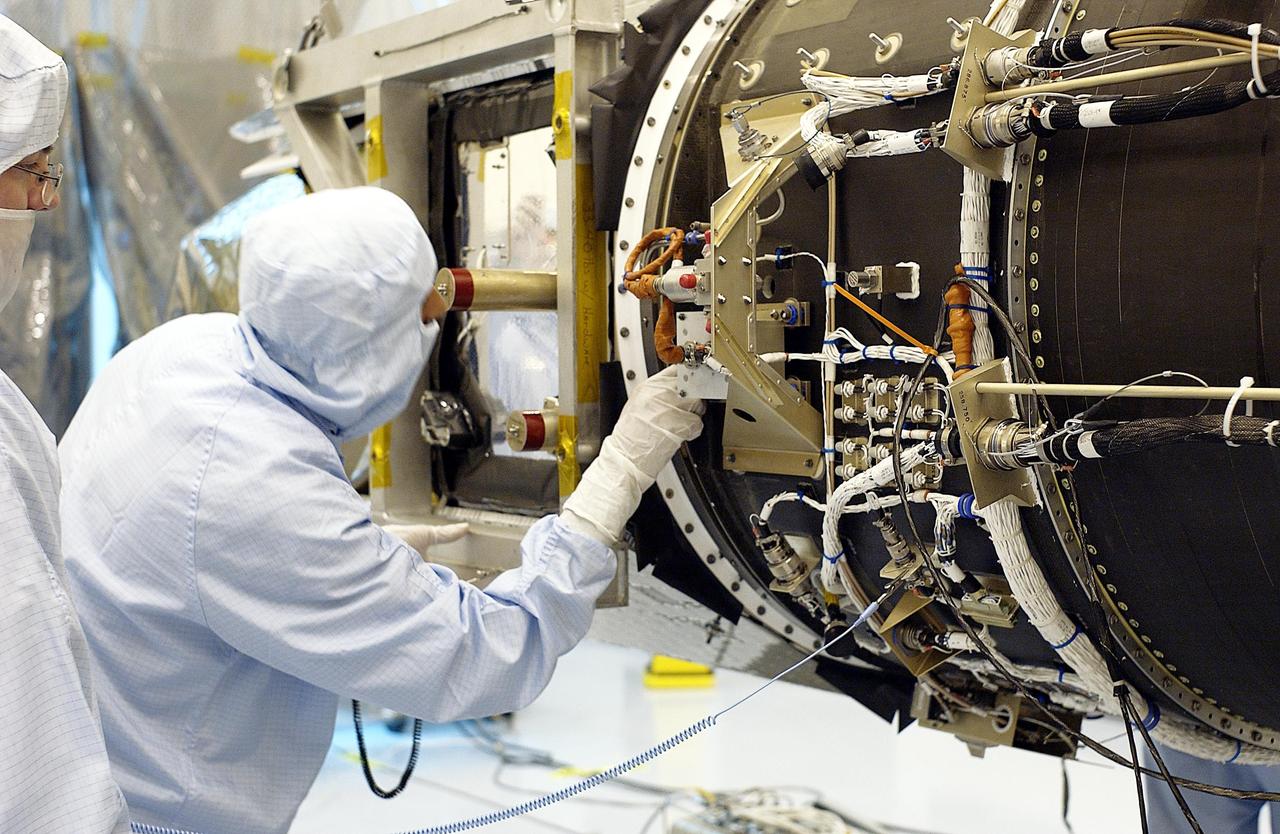 KENNEDY SPACE CENTER, Fla. - Workers in the Multi-Payload Processing Facility check the Galaxy Evolution Explorer (GALEX) spacecraft as it is removed from the Pegasus XL launch vehicle. Foreign object debris shields will be installed before its launch. The GALEX is an orbiting space telescope that will observe galaxies in ultraviolet light across 10 billion years of cosmic history. During its 29-month mission GALEX will produce the first comprehensive map of a Universe of galaxies under construction, bringing more understanding how galaxies like the Milky Way were formed. The GALEX launch date is under review.