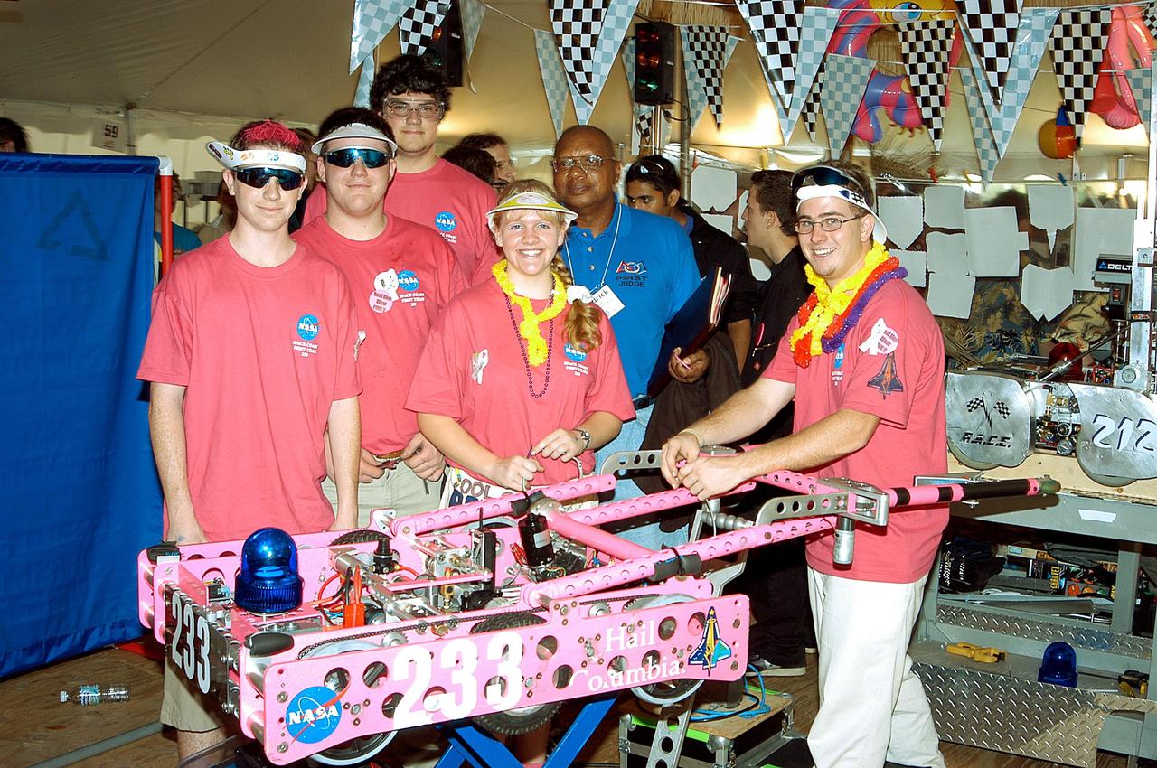 KENNEDY SPACE CENTER, FLA. - NASA/Kennedy Space Center-sponsored students, participating in the 2003 Southeastern Regional FIRST Robotic Competition, pose with their team-built robot. The competition is being held at the University of Central Florida (UCF) in Orlando, March 20-23. Forty student teams from around the country are participating in the event that pits team-built gladiator robots against each other in an athletic-style competition. The teams are sponsored by NASA/Kennedy Space Center, The Boeing Company/Brevard Community College, and Lockheed Martin Space Operations/Mission Systems for the nonprofit organization For Inspiration and Recognition of Science and Technology, known as FIRST. The vision of FIRST is to inspire in the youth of our nation an appreciation of science and technology and an understanding that mastering these disciplines can enrich the lives of all mankind.