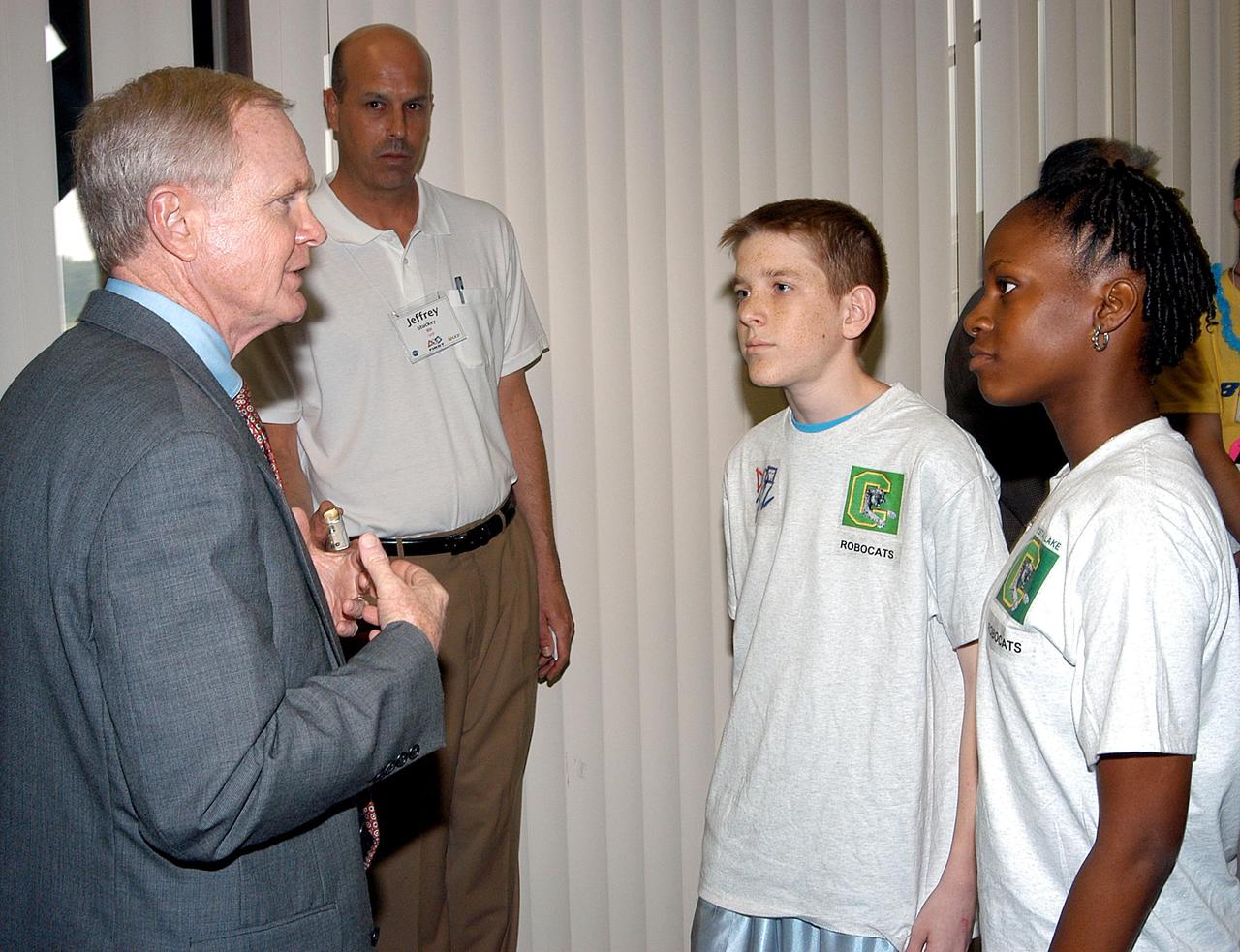 KENNEDY SPACE CENTER, FLA. - NASA Kennedy Space Center Director Roy Bridges (left) talks with some of the students involved in the 2003 Southeastern Regional FIRST Robotic Competition. The competition is being held at the University of Central Florida (UCF) in Orlando, March 20-23. Forty student teams from around the country are participating in the event that pits team-built gladiator robots against each other in an athletic-style competition. The teams are sponsored by NASA/Kennedy Space Center, The Boeing Company/Brevard Community College, and Lockheed Martin Space Operations/Mission Systems for the nonprofit organization For Inspiration and Recognition of Science and Technology, known as FIRST. The vision of FIRST is to inspire in the youth of our nation an appreciation of science and technology and an understanding that mastering these disciplines can enrich the lives of all mankind.