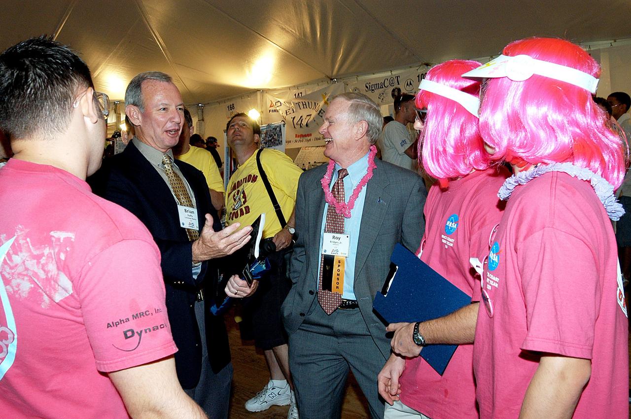 KENNEDY SPACE CENTER, FLA. -  Lockheed Martin Vice President/Associate Program Manager Brian Duffy (second from left) and NASA/Kennedy Space Center Director Roy Bridges (center) share a laugh with student participants in the 2003 Southeastern Regional FIRST Robotic Competition. The competition is being held at the University of Central Florida (UCF) in Orlando, March 20-23. Forty student teams from around the country are participating in the event that pits team-built gladiator robots against each other in an athletic-style competition. The teams are sponsored by NASA/Kennedy Space Center, The Boeing Company/Brevard Community College, and Lockheed Martin Space Operations/Mission Systems for the nonprofit organization For Inspiration and Recognition of Science and Technology, known as FIRST. The vision of FIRST is to inspire in the youth of our nation an appreciation of science and technology and an understanding that mastering these disciplines can enrich the lives of all mankind.