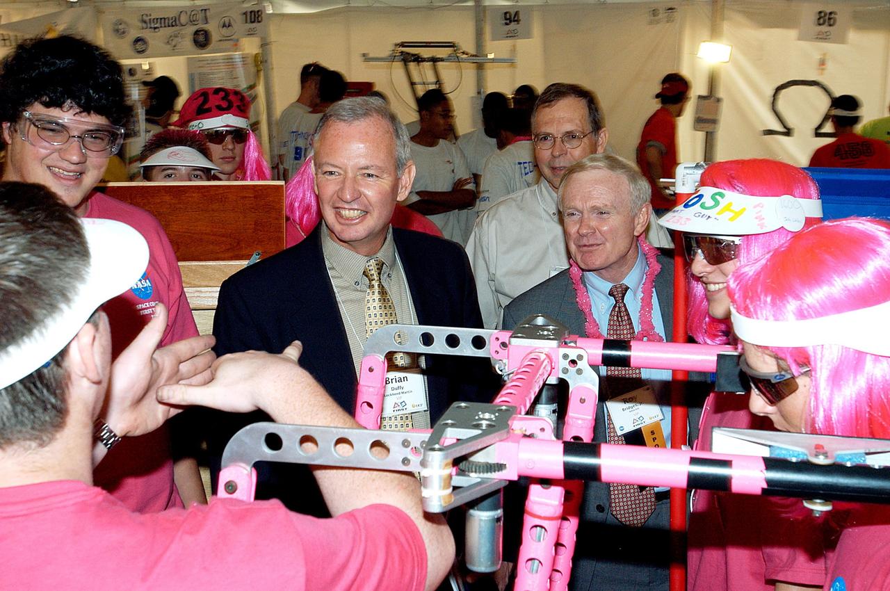 KENNEDY SPACE CENTER, FLA. -  Lockheed Martin Vice President/Associate Program Manager Brian Duffy (second from left) and NASA Kennedy Space Center Director Roy Bridges (next to Duffy) talk with student participants in the 2003 Southeastern Regional FIRST Robotic Competition. Chris Fairey, the former director of Spaceport Services at KSC, looks on in the background. The competition is being held at the University of Central Florida (UCF) in Orlando, March 20-23. Forty student teams from around the country are participating in the event that pits team-built gladiator robots against each other in an athletic-style competition. The teams are sponsored by NASA/Kennedy Space Center, The Boeing Company/Brevard Community College, and Lockheed Martin Space Operations/Mission Systems for the nonprofit organization For Inspiration and Recognition of Science and Technology, known as FIRST. The vision of FIRST is to inspire in the youth of our nation an appreciation of science and technology and an understanding that mastering these disciplines can enrich the lives of all mankind.