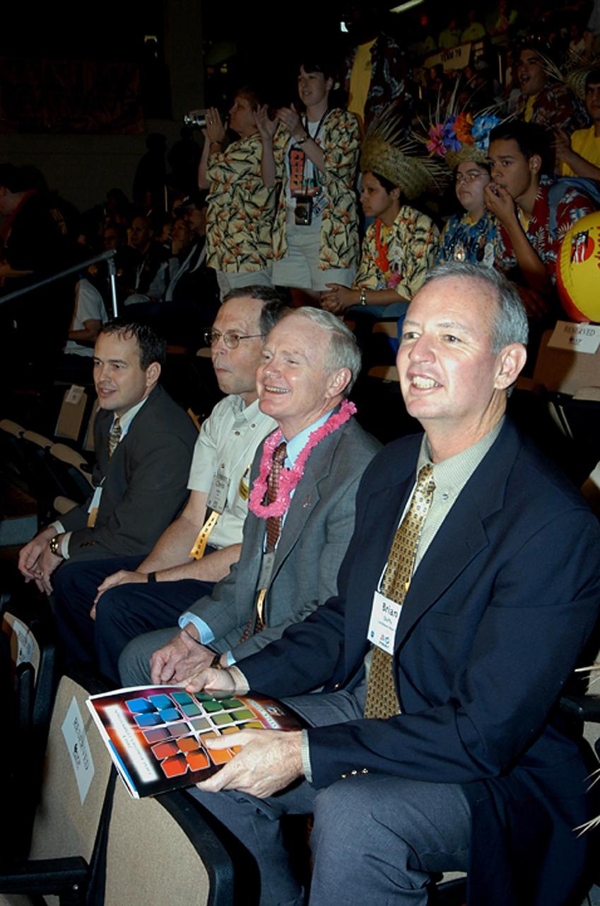 KENNEDY SPACE CENTER, FLA. -  Observing the festivities at the 2003 Southeastern Regional FIRST Robotic Competition are, from left, David Culp, executive intern to the director of KSC; Chris Fairey, former director of Spaceport Services at KSC; Roy Bridges, KSC director; and Brian Duffy, Lockheed Martin vice president/associate program manager. The competition is being held at the University of Central Florida (UCF) in Orlando, March 20-23. Forty student teams from around the country are participating in the event that pits team-built gladiator robots against each other in an athletic-style competition. The teams are sponsored by NASA/Kennedy Space Center, The Boeing Company/Brevard Community College, and Lockheed Martin Space Operations/Mission Systems for the nonprofit organization For Inspiration and Recognition of Science and Technology, known as FIRST. The vision of FIRST is to inspire in the youth of our nation an appreciation of science and technology and an understanding that mastering these disciplines can enrich the lives of all mankind.