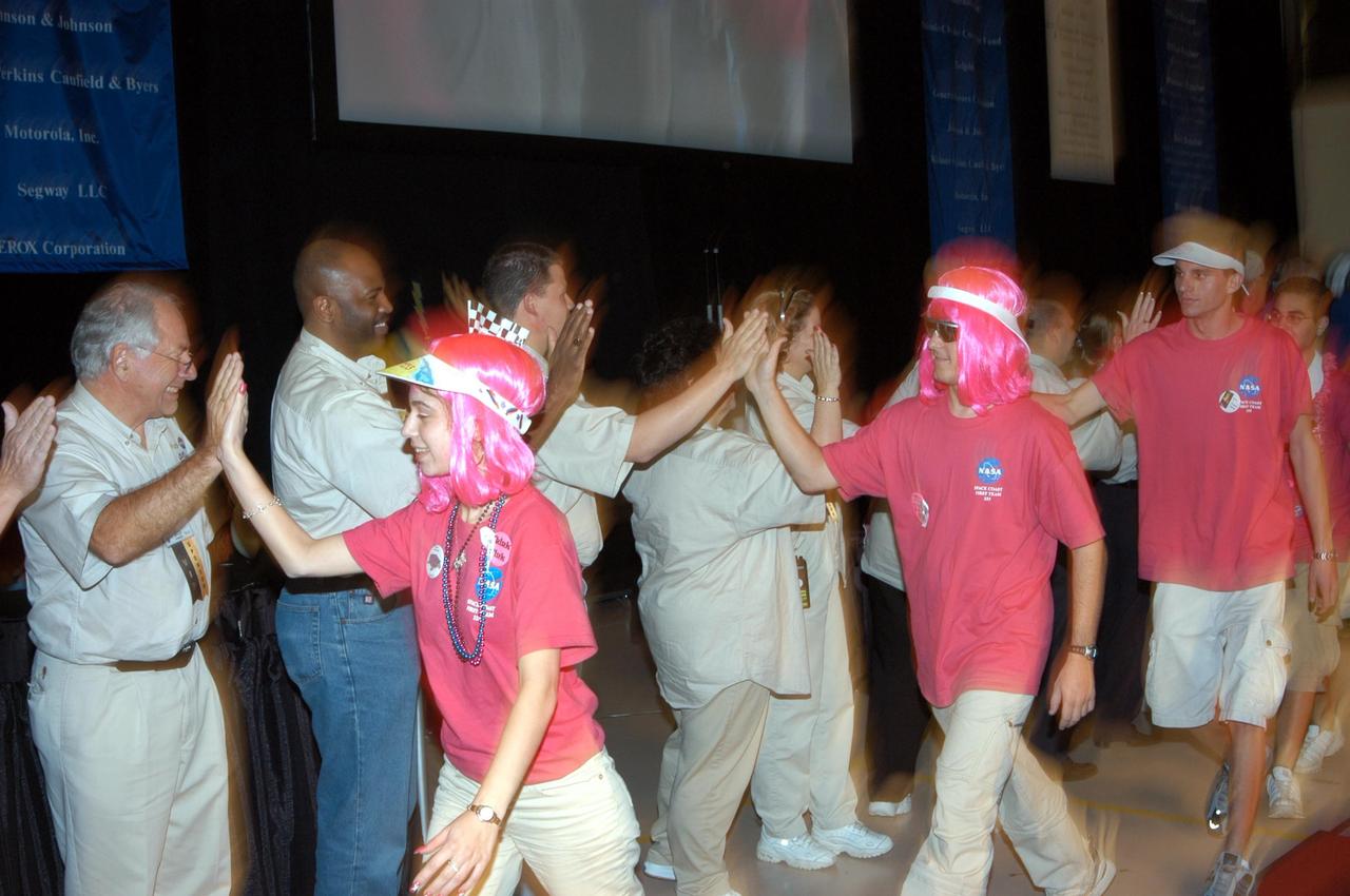 KENNEDY SPACE CENTER, FLA. - The NASA/Kennedy Space Center-sponsored student team (in pink wigs) is congratulated by the mentors and support staff of the 2003 Southeastern Regional FIRST Robotic Competition. The competition is being held at the University of Central Florida (UCF) in Orlando, March 20-23. The team won awards for Regional Finalist 2, GM Industrial Design and the Imagery Award. Forty student teams from around the country are participating in the event that pits team-built gladiator robots against each other in an athletic-style competition. The teams are sponsored by NASA/Kennedy Space Center, The Boeing Company/Brevard Community College, and Lockheed Martin Space Operations/Mission Systems for the nonprofit organization For Inspiration and Recognition of Science and Technology, known as FIRST. The vision of FIRST is to inspire in the youth of our nation an appreciation of science and technology and an understanding that mastering these disciplines can enrich the lives of all mankind.