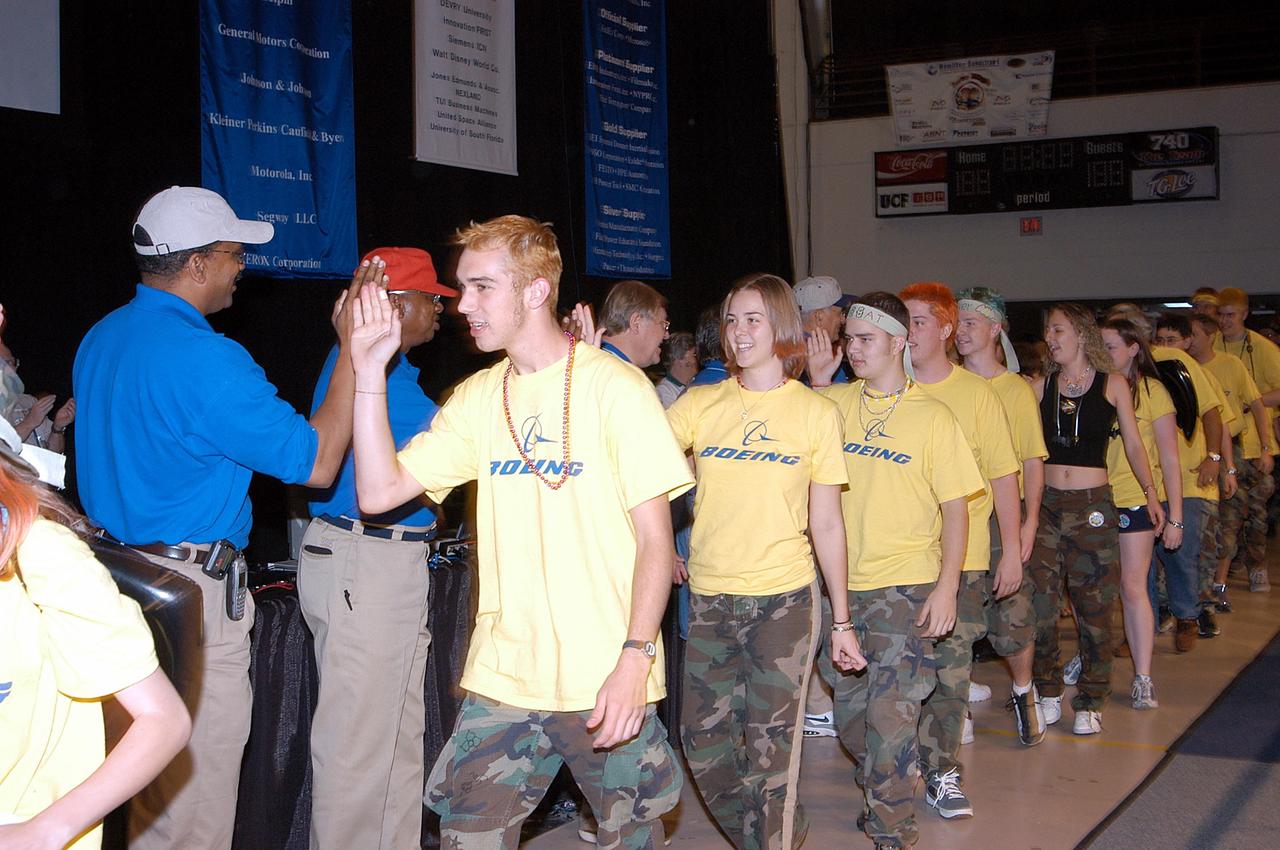 KENNEDY SPACE CENTER, FLA. -  The Boeing Company/Brevard Community College-sponsored student team (in yellow shirts) is congratulated by the judges and support staff of the 2003 Southeastern Regional FIRST Robotic Competition. The competition is being held at the University of Central Florida (UCF) in Orlando, March 20-23. The team won the DaimlerChrysler Team Spirit Award and the Johnson & Johnson Sportsmanship Award.  Forty student teams from around the country are participating in the event that pits team-built gladiator robots against each other in an athletic-style competition. The teams are sponsored by NASA/Kennedy Space Center, The Boeing Company/Brevard Community College, and Lockheed Martin Space Operations/Mission Systems for the nonprofit organization For Inspiration and Recognition of Science and Technology, known as FIRST. The vision of FIRST is to inspire in the youth of our nation an appreciation of science and technology and an understanding that mastering these disciplines can enrich the lives of all mankind.