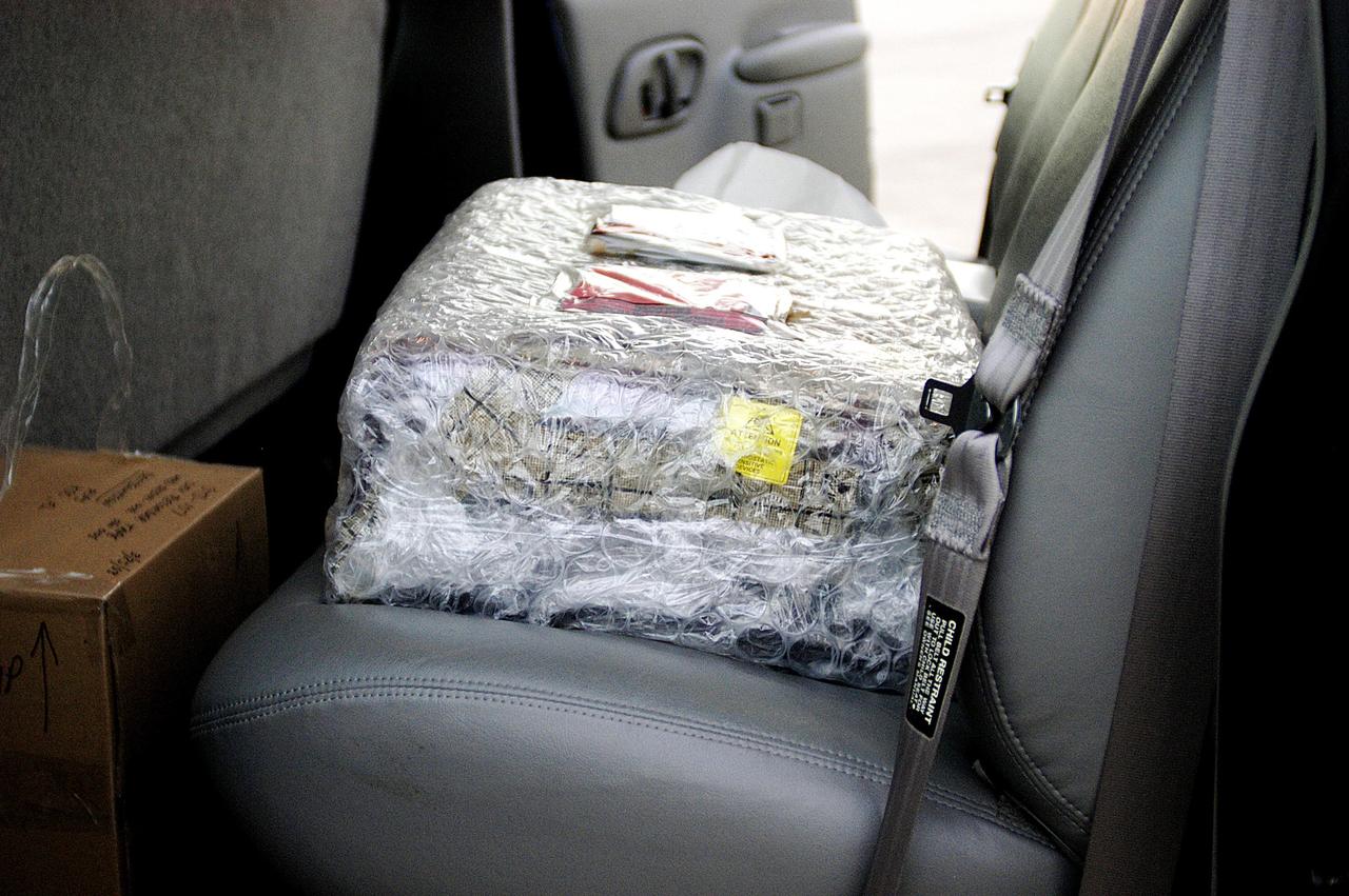 KENNEDY SPACE CENTER, FLA. -  The Orbiter Experiment Support System (OEX) recorder from Columbia, in protective covering, rests inside a transport vehicle after its arrival at KSC aboard a T-38 jet aircraft.   Search teams near Hemphill, Texas, recovered the recorder, which stores sensor information about temperature, aerodynamic pressure, vibrations and other data from dozens of sensor locations on the orbiter, operating only during launch and re-entry. The OEX uses magnetic tape to record data that is not sent to the ground by telemetry.