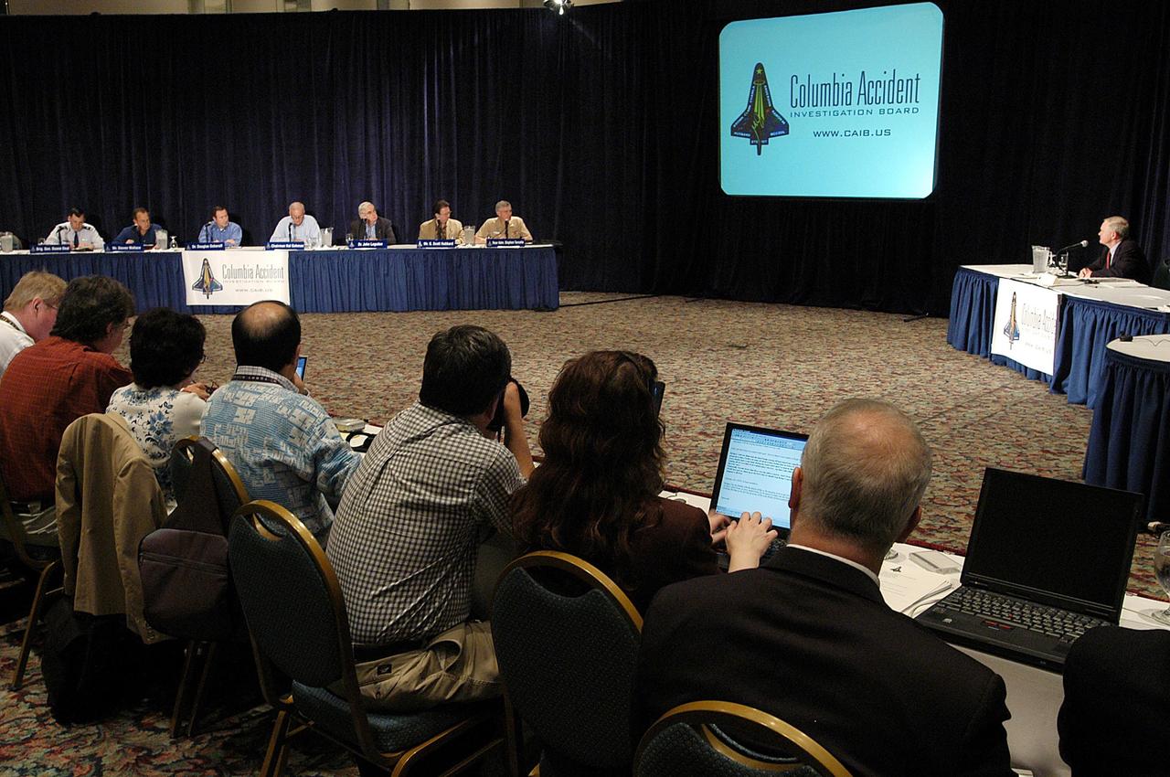 KENNEDY SPACE CENTER, FLA. -  At the third public hearing of the Columbia Accident Investigation Board, held in Cape Canaveral, Fla., reporters listen intently to Center Director Roy Bridges (background, right).  Board members are in the background, left.  Over the course of two days, the Board's chairman, retired Navy Admiral Harold W. "Hal" Gehman Jr., and other board members would hear from experts discussing the role of the Kennedy Space Center in the Shuttle Program, Shuttle Safety and Debris Collection, Layout and Analysis and Forensic Metallurgy.