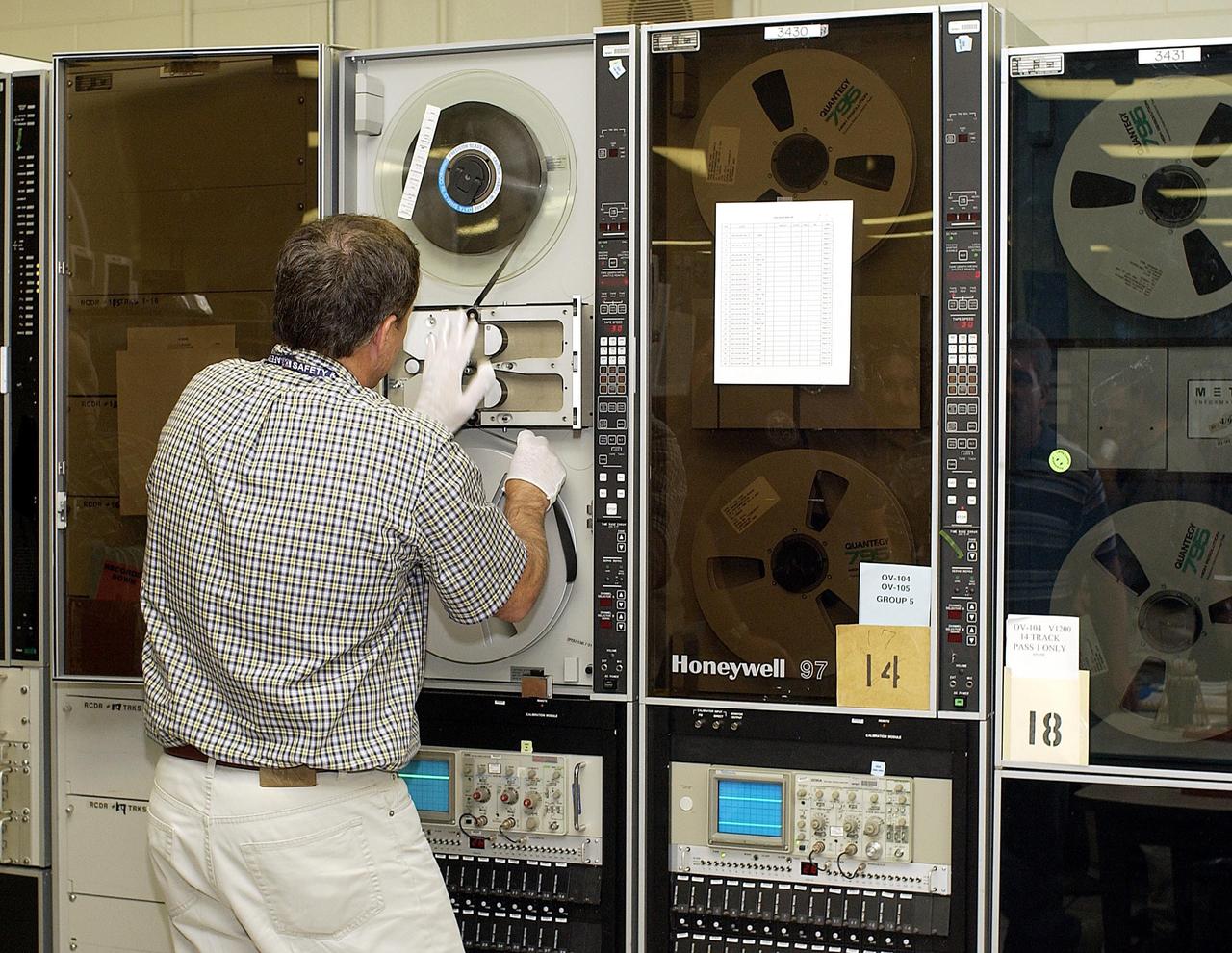 KENNEDY SPACE CENTER, FLA. --  Columbia's Orbiter Experiment  Support System (OEX) recorder is put on taping equipment in the KSC Launch Control Center. The recorder tape is being duplicated and will be reviewed at the Johnson Space Center in Houston and other facilities. No actual sensor data on that tape has been reviewed at this time,  Search teams near Hemphill, Texas recovered the recorder, which stores sensor information about temperature, aerodynamic pressure, vibrations and other data from dozens of sensor locations on the orbiter, operating only during launch and re-entry. The OEX uses magnetic tape to record data that is not sent to the ground by telemetry.
