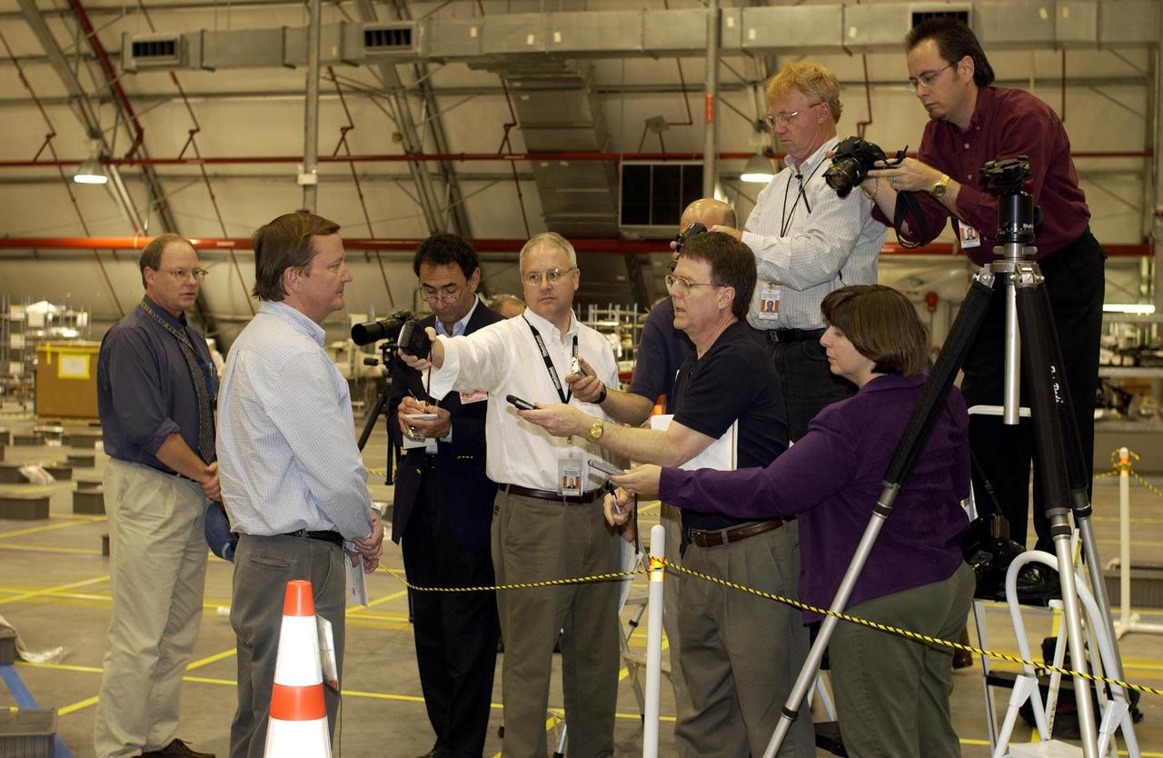 KENNEDY SPACE CENTER, FLA. -  Shuttle Launch Director Mike Leinbach answers reporters' questions in the RLV Hangar.   Leinbach is overseeing assessment of the debris as it is delivered to KSC.  The Columbia Reconstruction Project team is identifying pieces and placing them on a grid approximating the shape of the orbiter.  About 25 percent of the orbiter has been delivered to the hangar.