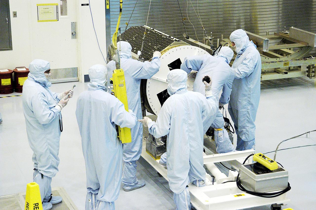 KENNEDY SPACE CENTER, FLA. - Technicians prepare to lift the Galaxy Evolution Explorer (GALEX) spacecraft into a vertical position after it is demated from its Pegasus launch vehicle in the Payload Hazardous Servicing Facility. A borescope inspection will be conducted to locate a small fastener and associated clip missing from a demated connector identified during preflight testing. GALEX is an orbiting space telescope that will observe galaxies in ultraviolet light across 10 billion years of cosmic history. During its 29-month mission, GALEX will produce the first comprehensive map of a Universe of galaxies under construction, bringing more understanding to how galaxies like the Milky Way were formed. The GALEX launch date in late April is currently under review.