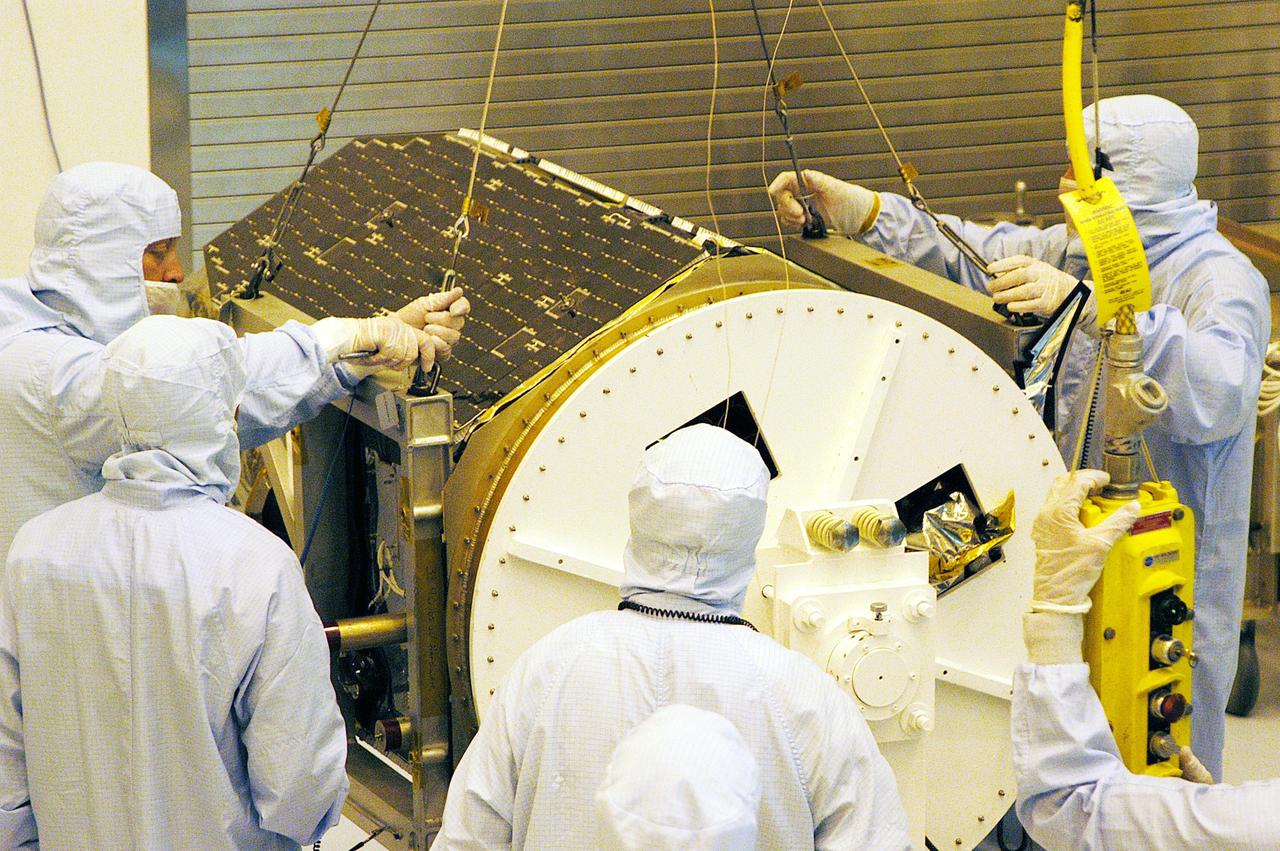 KENNEDY SPACE CENTER, FLA. - Technicians prepare to lift the Galaxy Evolution Explorer (GALEX) spacecraft into a vertical position after it is demated from its Pegasus launch vehicle in the Payload Hazardous Servicing Facility. A borescope inspection will be conducted to locate a small fastener and associated clip missing from a demated connector identified during preflight testing. GALEX is an orbiting space telescope that will observe galaxies in ultraviolet light across 10 billion years of cosmic history. During its 29-month mission, GALEX will produce the first comprehensive map of a Universe of galaxies under construction, bringing more understanding to how galaxies like the Milky Way were formed. The GALEX launch date in late April is currently under review.
