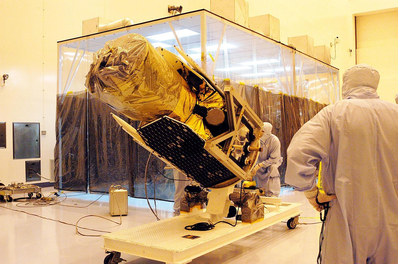 KENNEDY SPACE CENTER, FLA. -  Technicians lift the Galaxy Evolution Explorer (GALEX) spacecraft into a vertical position after it is demated from its Pegasus launch vehicle in the Payload Hazardous Servicing Facility. A borescope inspection will be conducted to locate a small fastener and associated clip missing from a demated connector identified during preflight testing. GALEX is an orbiting space telescope that will observe galaxies in ultraviolet light across 10 billion years of cosmic history. During its 29-month mission, GALEX will produce the first comprehensive map of a Universe of galaxies under construction, bringing more understanding to how galaxies like the Milky Way were formed. The GALEX launch date in late April is currently under review.