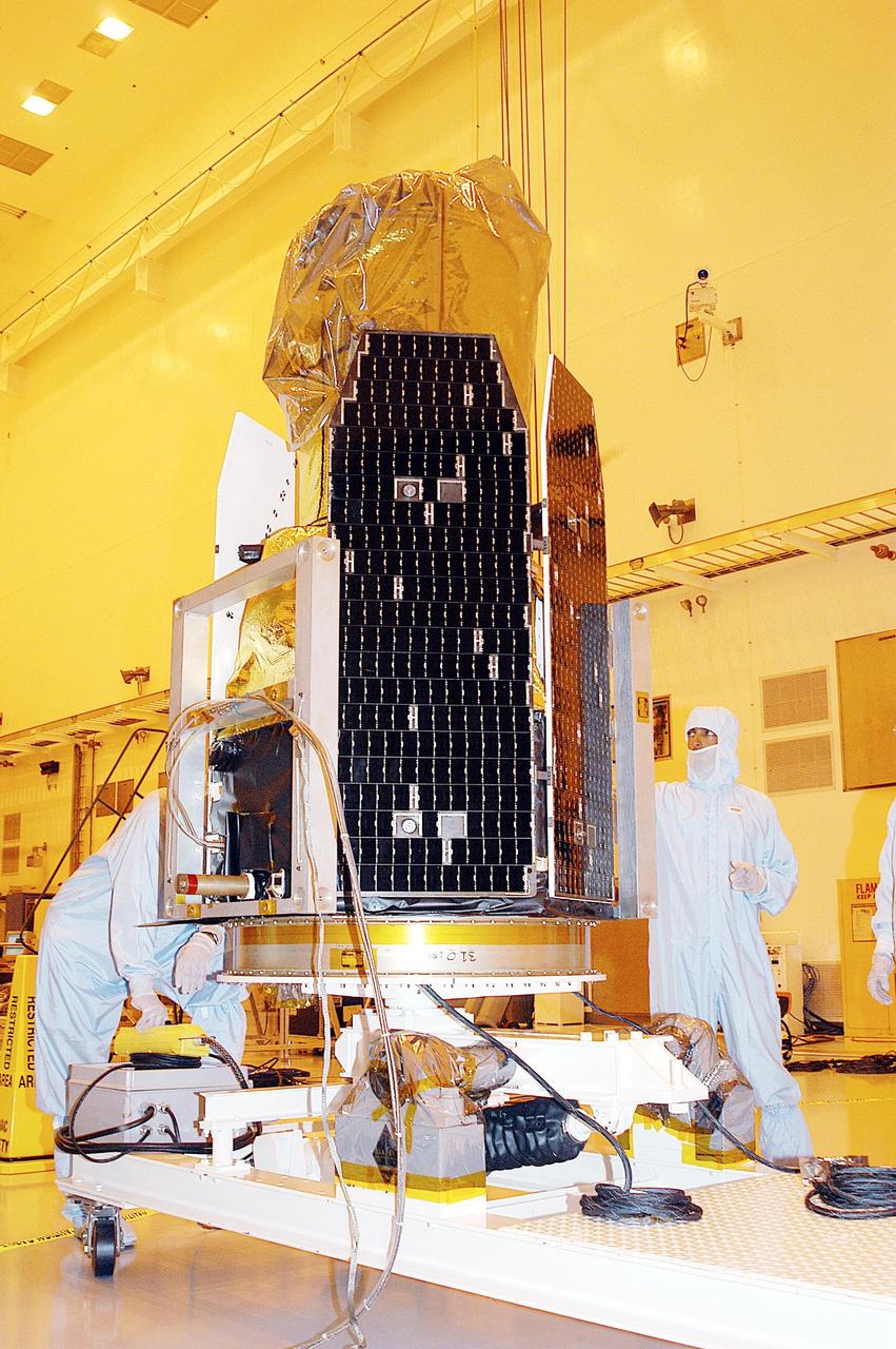 KENNEDY SPACE CENTER, FLA. -  Technicians lift the Galaxy Evolution Explorer (GALEX) spacecraft into a vertical position after it is demated from its Pegasus launch vehicle in the Payload Hazardous Servicing Facility. A borescope inspection will be conducted to locate a small fastener and associated clip missing from a demated connector identified during preflight testing. GALEX is an orbiting space telescope that will observe galaxies in ultraviolet light across 10 billion years of cosmic history. During its 29-month mission, GALEX will produce the first comprehensive map of a Universe of galaxies under construction, bringing more understanding to how galaxies like the Milky Way were formed. The GALEX launch date in late April is currently under review.