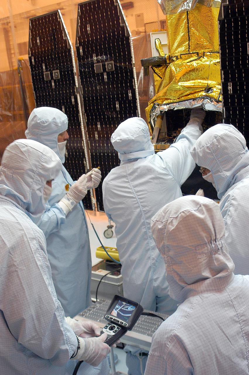 KENNEDY SPACE CENTER, FLA. - Foreign object debris shields are installed and a borescope inspection is conducted on the Galaxy Evolution Explorer (GALEX) spacecraft in the Payload Hazardous Servicing Facility. Technicians are looking for a small fastener and associated clip missing from a demated connector identified during preflight testing. GALEX is an orbiting space telescope that will observe galaxies in ultraviolet light across 10 billion years of cosmic history. During its 29-month mission, GALEX will produce the first comprehensive map of a Universe of galaxies under construction, bringing more understanding to how galaxies like the Milky Way were formed. The GALEX launch date in late April is currently under review.