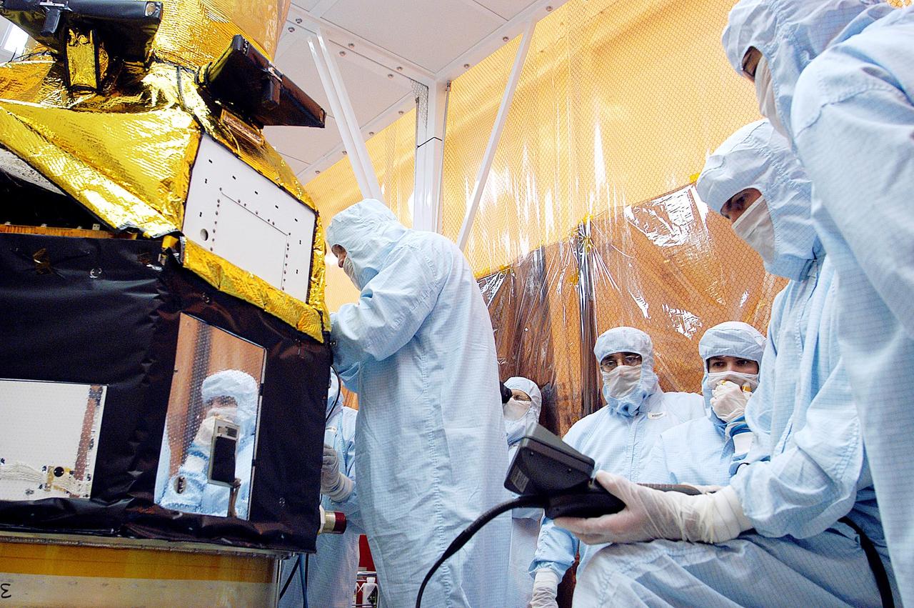 KENNEDY SPACE CENTER, FLA. - Foreign object debris shields are installed and a borescope inspection is conducted on the Galaxy Evolution Explorer (GALEX) spacecraft in the Payload Hazardous Servicing Facility. Technicians are looking for a small fastener and associated clip missing from a demated connector identified during preflight testing. GALEX is an orbiting space telescope that will observe galaxies in ultraviolet light across 10 billion years of cosmic history. During its 29-month mission, GALEX will produce the first comprehensive map of a Universe of galaxies under construction, bringing more understanding to how galaxies like the Milky Way were formed. The GALEX launch date in late April is currently under review.