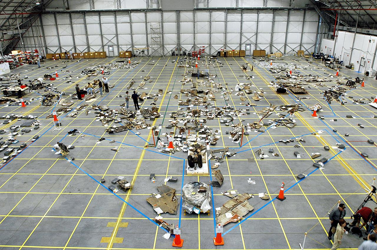 KENNEDY SPACE CENTER, FLA. -  A grid on the floor of the RLV Hangar is filling up with pieces of Columbia debris that have been collected by workers in the field. The blue lines reflect the outline of the orbiter. The Columbia Reconstruction Project Team is identifying pieces and placing them on the grid approximating their location on the orbiter to facilitate the investigation into the accident that caused the destruction of Columbia and loss of its crew as it returned to Earth following mission STS-107. To date, about 25 percent of the orbiter has been delivered to the hangar.