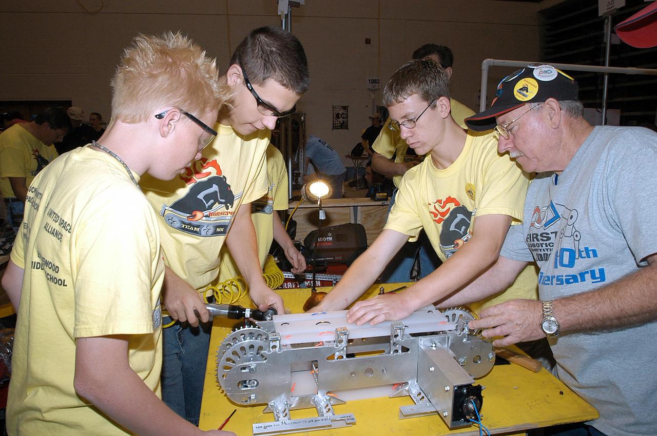 KENNEDY SPACE CENTER, FLA. -- The Merritt Island and Edgewood Middle School students/Lockheed Martin team, participating in the 2003 Southeastern  Regional FIRST Robotic Competition, work on their team-built robot. The competition is being held at the University of Central Florida (UCF) in Orlando, March 20-23. Forty teams from around the country are participating in the event that pits team-built gladiator robots against each other in an athletic-style competition. The teams are sponsored by NASA-Kennedy Space Center, The Boeing Company/Brevard Community College, and Lockheed Martin Space Operations/Mission Systems for the nonprofit organization For Inspiration and Recognition of Science and Technology, known as FIRST. The vision of FIRST is to inspire in the youth of our nation an appreciation of science and technology and an understanding that mastering these disciplines can enrich the lives of all mankind.