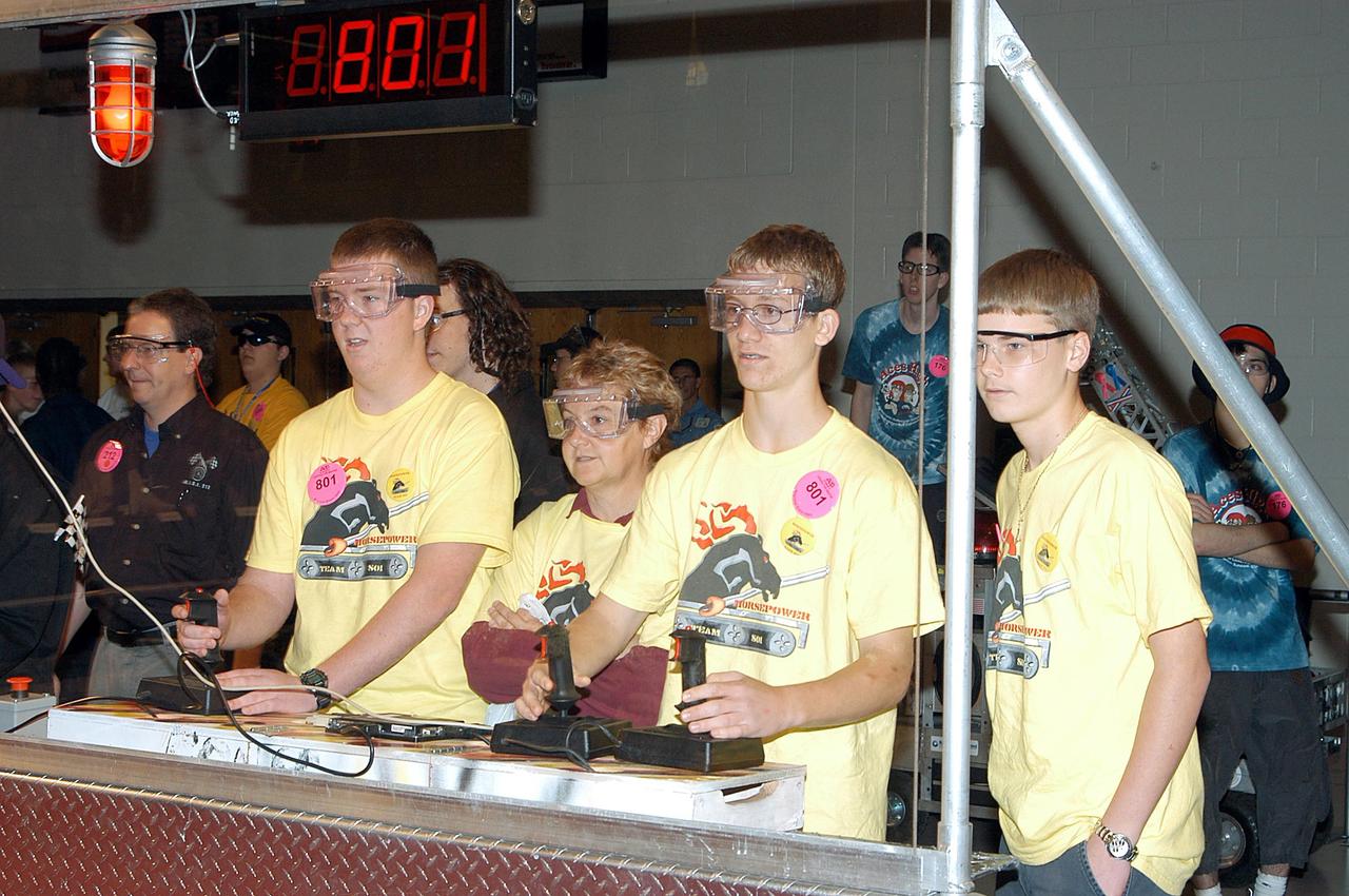 KENNEDY SPACE CENTER, FLA. -  Members of the Merritt Island and Edgewood Middle School students/Lockheed Martin team maneuver their robot during competition.  They are participating in the 2003 Southeastern  Regional FIRST Robotic Competition being held at the University of Central Florida (UCF) in Orlando, March 20-23. Forty teams from around the country are participating in the event that pits team-built gladiator robots against each other in an athletic-style competition. The teams are sponsored by NASA-Kennedy Space Center, The Boeing Company/Brevard Community College, and Lockheed Martin Space Operations/Mission Systems for the nonprofit organization For Inspiration and Recognition of Science and Technology, known as FIRST. The vision of FIRST is to inspire in the youth of our nation an appreciation of science and technology and an understanding that mastering these disciplines can enrich the lives of all mankind.