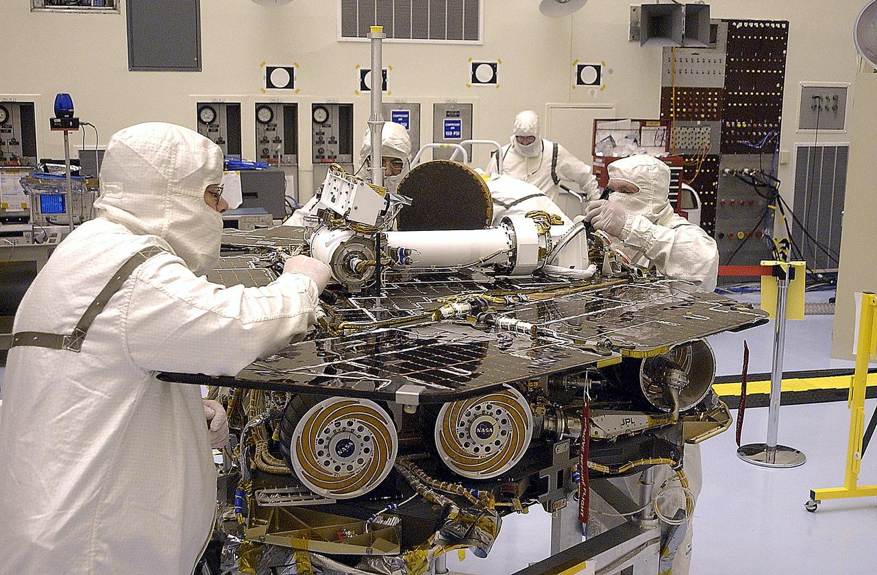 KENNEDY SPACE CENTER, FLA. -  In the Payload Hazardous Servicing Facility, workers check the solar panels on the Mars Exploration Rover 2 (MER-2) before flight stow. Set to launch in Spring 2003, the MER Mission will consist of two identical rovers designed to cover roughly 110 yards each Martian day over various terrain. The rovers will be identical to each other, but will land at different regions of Mars.  Each rover will carry five scientific instruments that will allow it to search for evidence of liquid water that may have been present in the planet's past.  The first rover has a launch window opening May 30, and the second rover a window opening June 25.