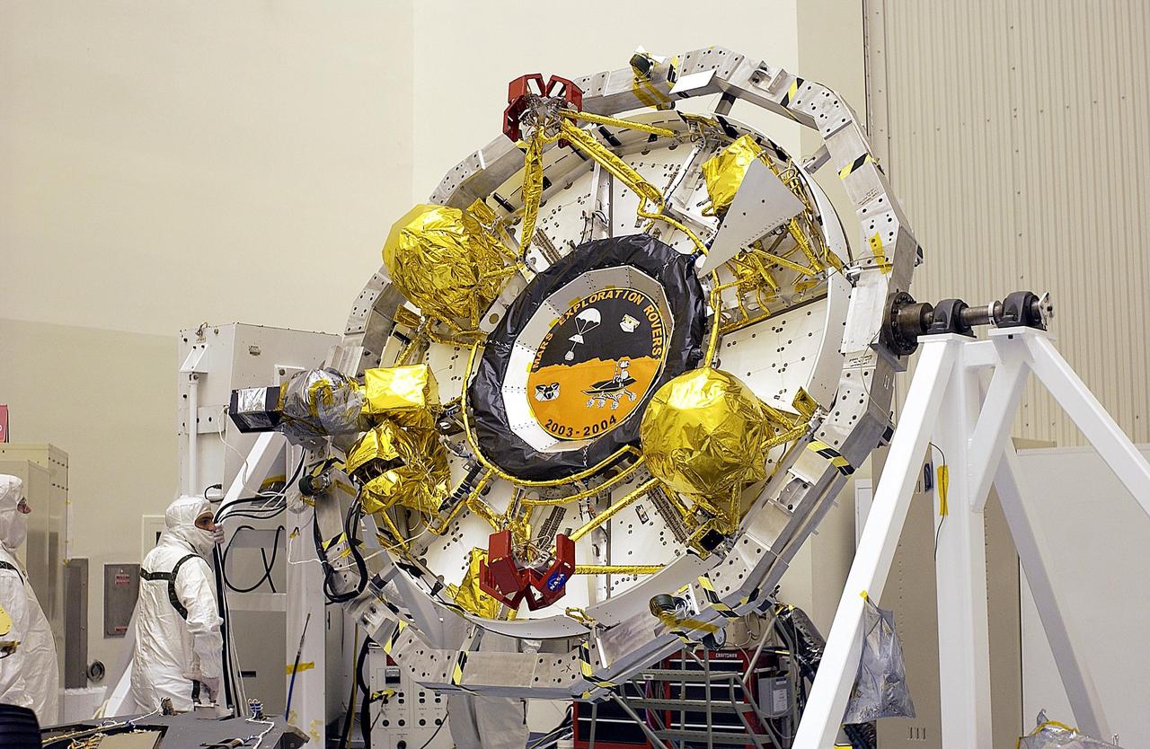 KENNEDY SPACE CENTER, FLA. -- The cruise stage for one of the Mars Exploration Rovers is rotated for processing. Once functional testing and mission simulation of the flight elements is complete, the elements will be integrated for flight. There are two rovers, identical to each other, and each will land at different regions of Mars. They are designed to cover roughly 110 yards each Martian day over various terrain. Each rover will carry five scientific instruments that will allow it to search for evidence of liquid water that may have been present in the planet's past. The first rover has a launch window opening May 30, and the second rover a window opening June 25.