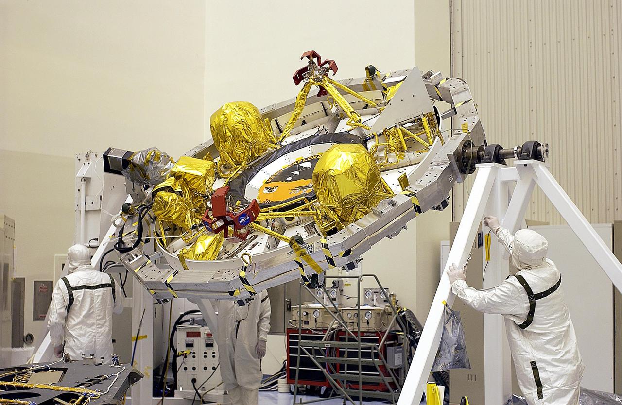 KENNEDY SPACE CENTER, FLA. -- The cruise stage for one of the Mars Exploration Rovers is rotated for processing. Once functional testing and mission simulation of the flight elements is complete, the elements will be integrated for flight. There are two rovers, identical to each other, and each will land at different regions of Mars. They are designed to cover roughly 110 yards each Martian day over various terrain. Each rover will carry five scientific instruments that will allow it to search for evidence of liquid water that may have been present in the planet's past. The first rover has a launch window opening May 30, and the second rover a window opening June 25.
