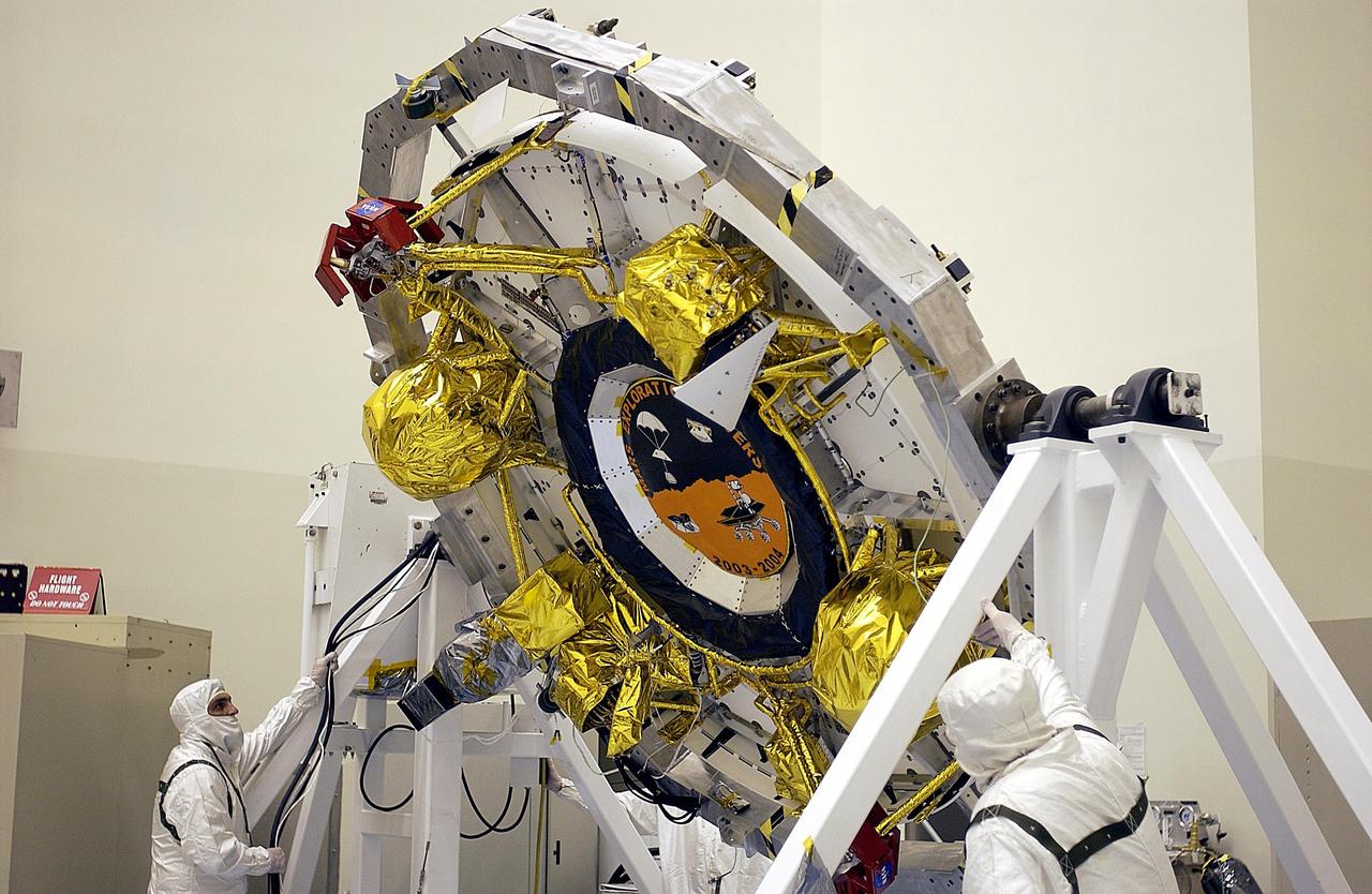 KENNEDY SPACE CENTER, FLA. -- The cruise stage for one of the Mars Exploration Rovers is rotated for processing. Once functional testing and mission simulation of the flight elements is complete, the elements will be integrated for flight. There are two rovers, identical to each other, and each will land at different regions of Mars. They are designed to cover roughly 110 yards each Martian day over various terrain. Each rover will carry five scientific instruments that will allow it to search for evidence of liquid water that may have been present in the planet's past. The first rover has a launch window opening May 30, and the second rover a window opening June 25.