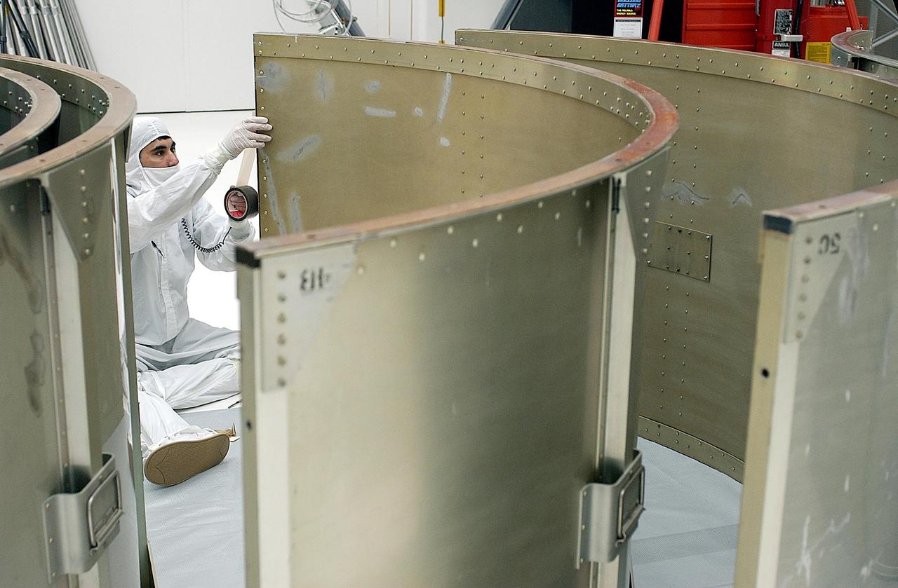 KENNEDY SPACE CENTER, FLA. -- A worker in Building AE prepares a segment of the payload canister for the Space Infrared Telescope Facility (SIRTF). SIRTF is currently scheduled for transportation to Launch Complex 17-B, Cape Canaveral Air Force Station, and mating with the Delta II on or about April 4.