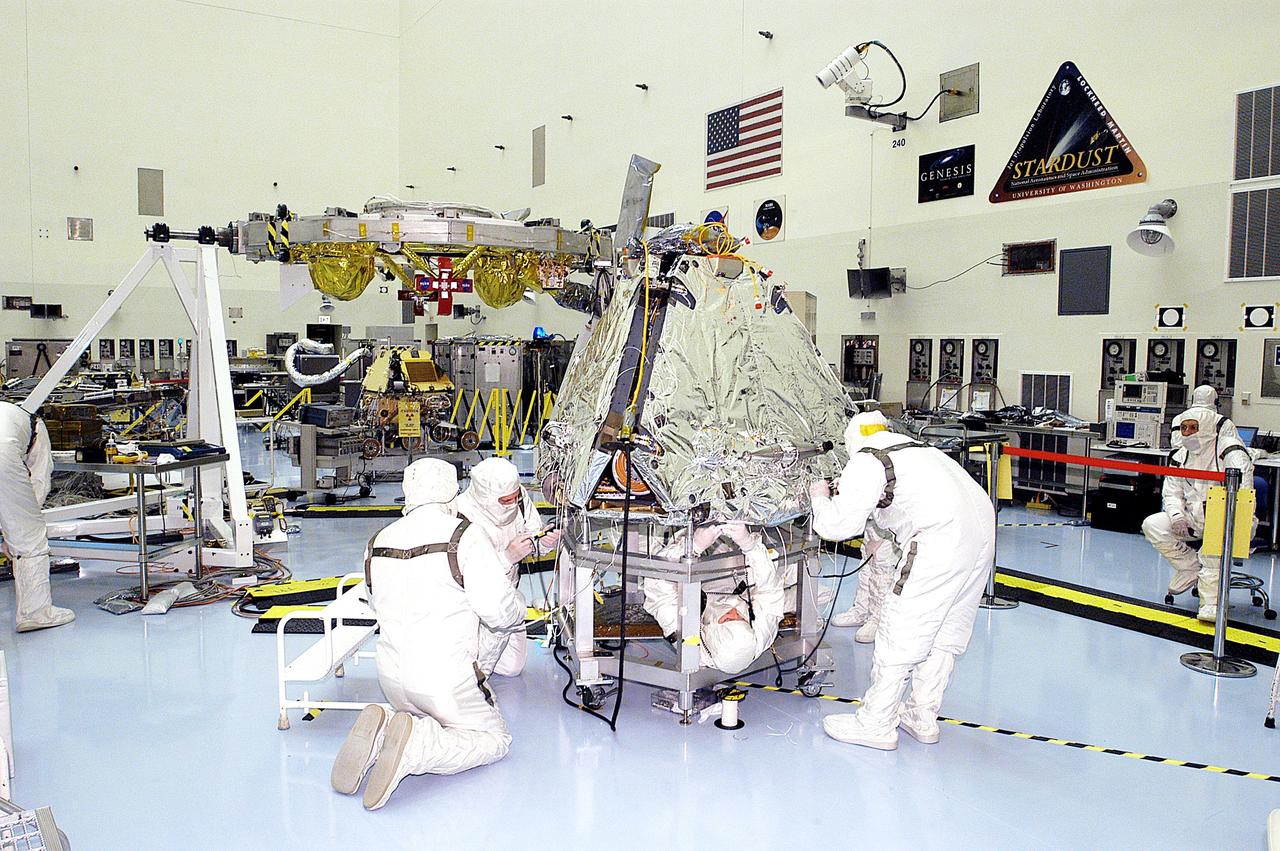 KENNEDY SPACE CENTER, FLA. - Workers prepare the shrouded Mars Exploration Rover 2 (MER-2) for mating to the lander. Set to launch in Spring 2003, the MER Mission consists of two identical rovers, landing at different regions of Mars, designed to cover roughly 110 yards each Martian day over various terrain. Each rover will carry five scientific instruments that will allow it to search for evidence of liquid water that may have been present in the planet's past. The first rover has a launch window opening May 30, and the second rover a window opening June 25.