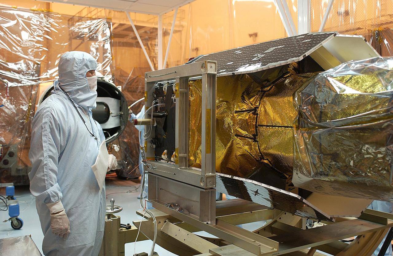 KENNEDY SPACE CENTER, FLA. -- Workers prepare the Pegasus XL launch vehicle for re-mate with the Galaxy Evolution Explorer (GALEX) spacecraft. The March 26 launch was delayed to enable protective covers to be added to the Optical Wheel Assembly (OWA) on GALEX to avoid the possibility of a missing electrical cable fastener floating into and jamming the mechanism when GALEX is in orbit. Launch of GALEX is now scheduled for no earlier than April 26.