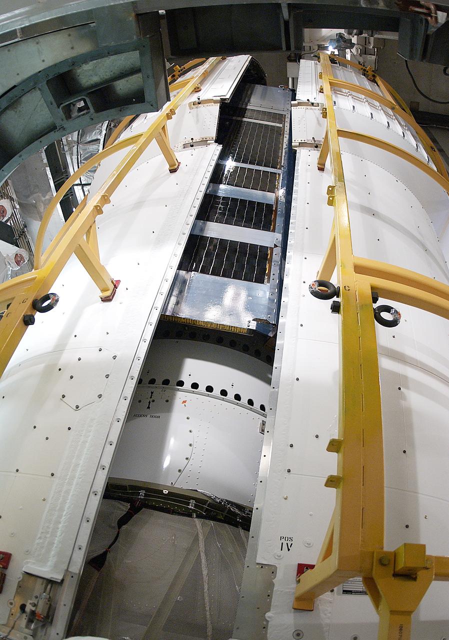 The two halves of the fairing move closer together around the Space Infrared Telescope Facility (SIRTF). SIRTF will obtain images and spectra by detecting the infrared energy, or heat, radiated by objects in space. Most of this infrared radiation is blocked by the Earth's atmosphere and cannot be observed from the ground. Consisting of an 0.85-meter telescope and three cryogenically cooled science instruments, SIRTF is one of NASA's largest infrared telescopes to be launched. SIRTF is currently scheduled for launch April 18 aboard a Delta II rocket from Launch Complex 17-B, Cape Canaveral Air Force Station. 