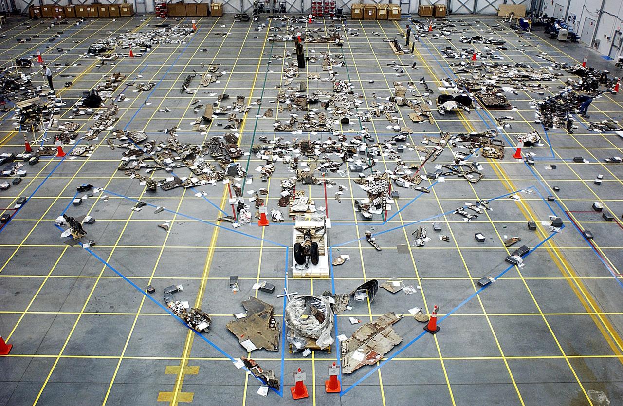 KENNEDY SPACE CENTER, FLA. -- Debris pieces of all sizes lie on the floor of the KSC RLV Hangar. Shipped from Barksdale Air Force Base, Shreveport, La., more than 70,000 items, weighing 78,000 pounds, about 36 percent of the Shuttle by weight, have been delivered to KSC for use in the mishap investigation. Ground teams have completed 78 percent of their primary search area, and airborne crews finished 80 percent of their assigned area. Search teams have completed 98 percent of the underwater searches in Lake Nacogdoches and Toledo Bend Reservoir.
