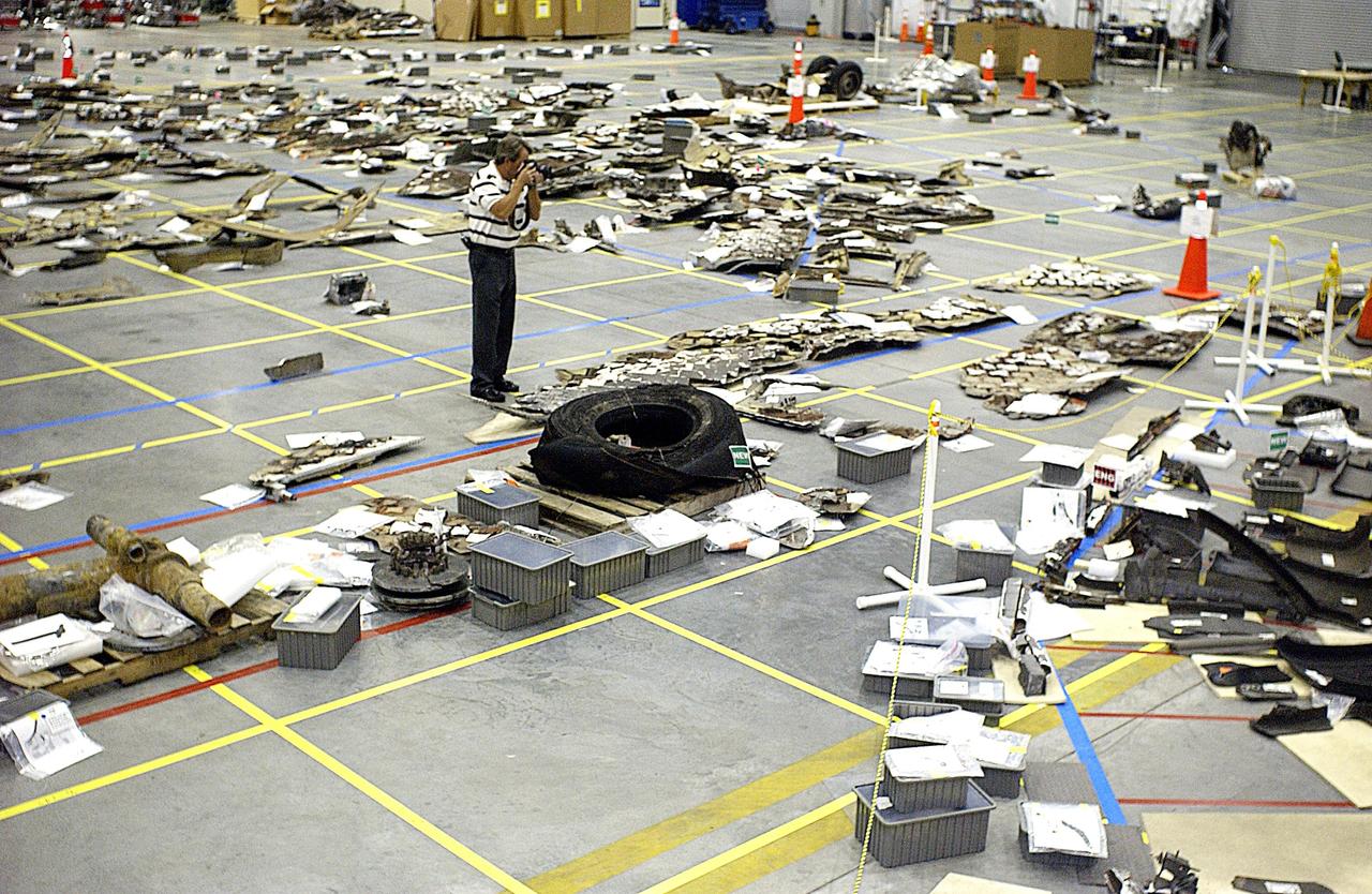 KENNEDY SPACE CENTER, FLA. - Pieces of Columbia debris are photographed by a KSC photographer.  More than 70,000 items, weighing 78,000  pounds, about 36 percent of the Shuttle by weight, have been  delivered to KSC for use in the mishap  investigation. Ground teams have completed 78 percent of their primary  search area, and airborne crews finished 80 percent of their  assigned area.  Search teams have completed 98 percent of the underwater searches in Lake Nacogdoches and Toledo Bend Reservoir.