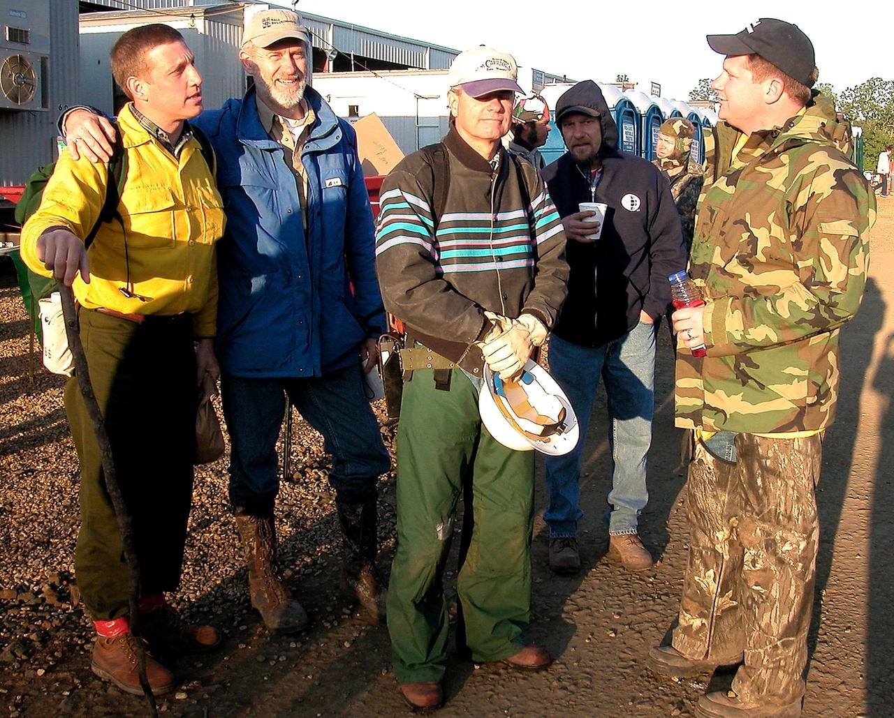 KENNEDY SPACE CENTER, FLA. -- Kennedy Space Center workers chat with Forest Service workers at the Hemphill site in East Texas before heading out to the field for grid searches. KSC workers are participating in the Columbia Recovery efforts at the Lufkin (Texas) Command Center, four field sites in East Texas, and the Barksdale, La., hangar site. KSC is working with representatives from other NASA Centers and with those from a number of federal, state and local agencies in the recovery effort. KSC provides vehicle technical expertise in the field to identify, collect and return Shuttle hardware to KSC.