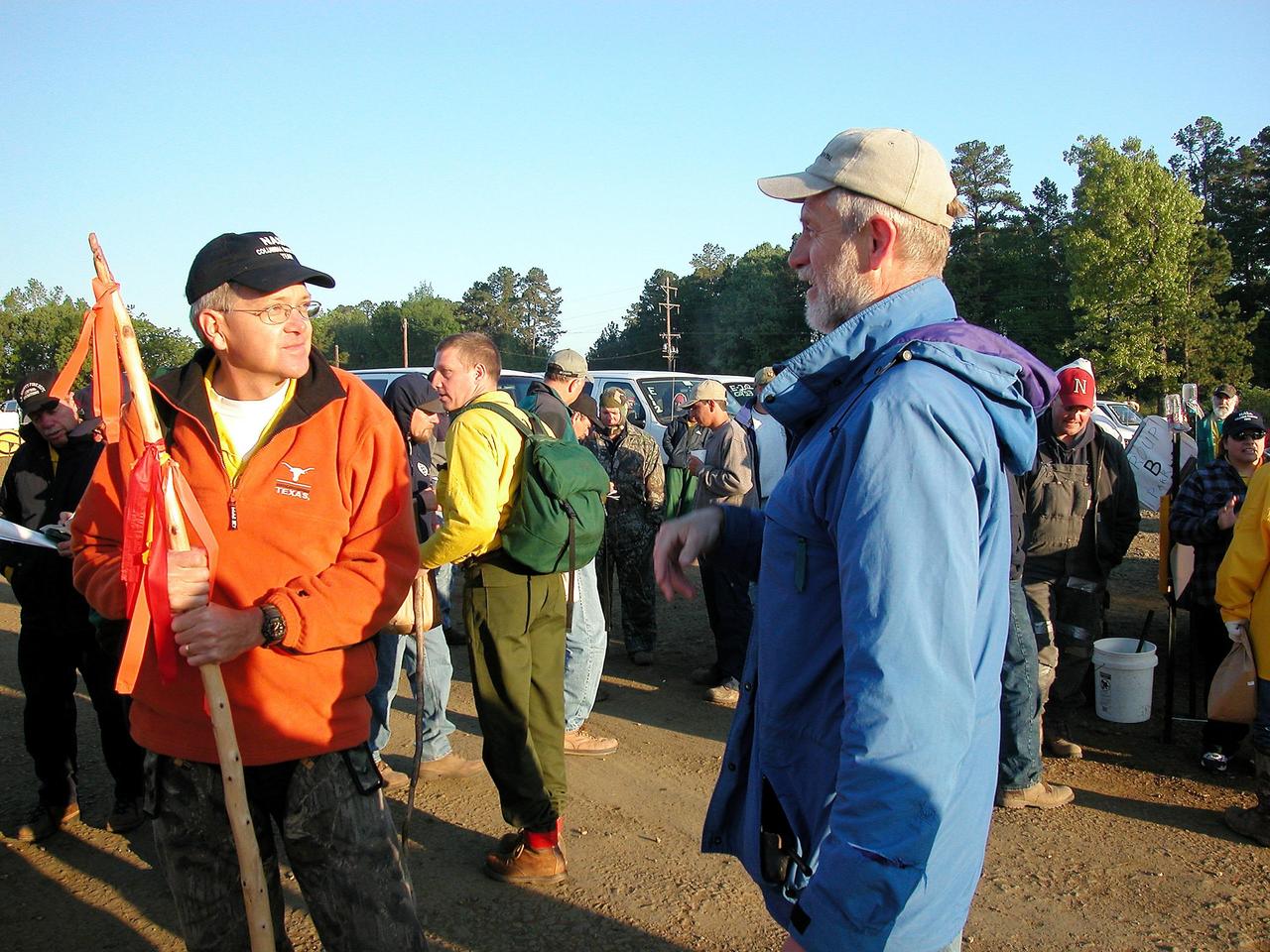 KENNEDY SPACE CENTER, FLA. --  At left, David Mclaughlin, Prototype Lab technician at Kennedy Space Center, listens to a coworker at the Hemphill site in East Texas before going to the field with his search team. Mclaughlin holds a walking stick used to beat down briars and knock away snakes in the East Texas woods. Kennedy Space Center workers are participating in the Columbia Recovery efforts at the Lufkin (Texas) Command Center, four field sites in East Texas, and the Barksdale, La., hangar site. KSC is working with representatives from other NASA Centers and with those from a number of federal, state and local agencies in the recovery effort. KSC provides vehicle technical expertise in the field to identify, collect and return Shuttle hardware to KSC.